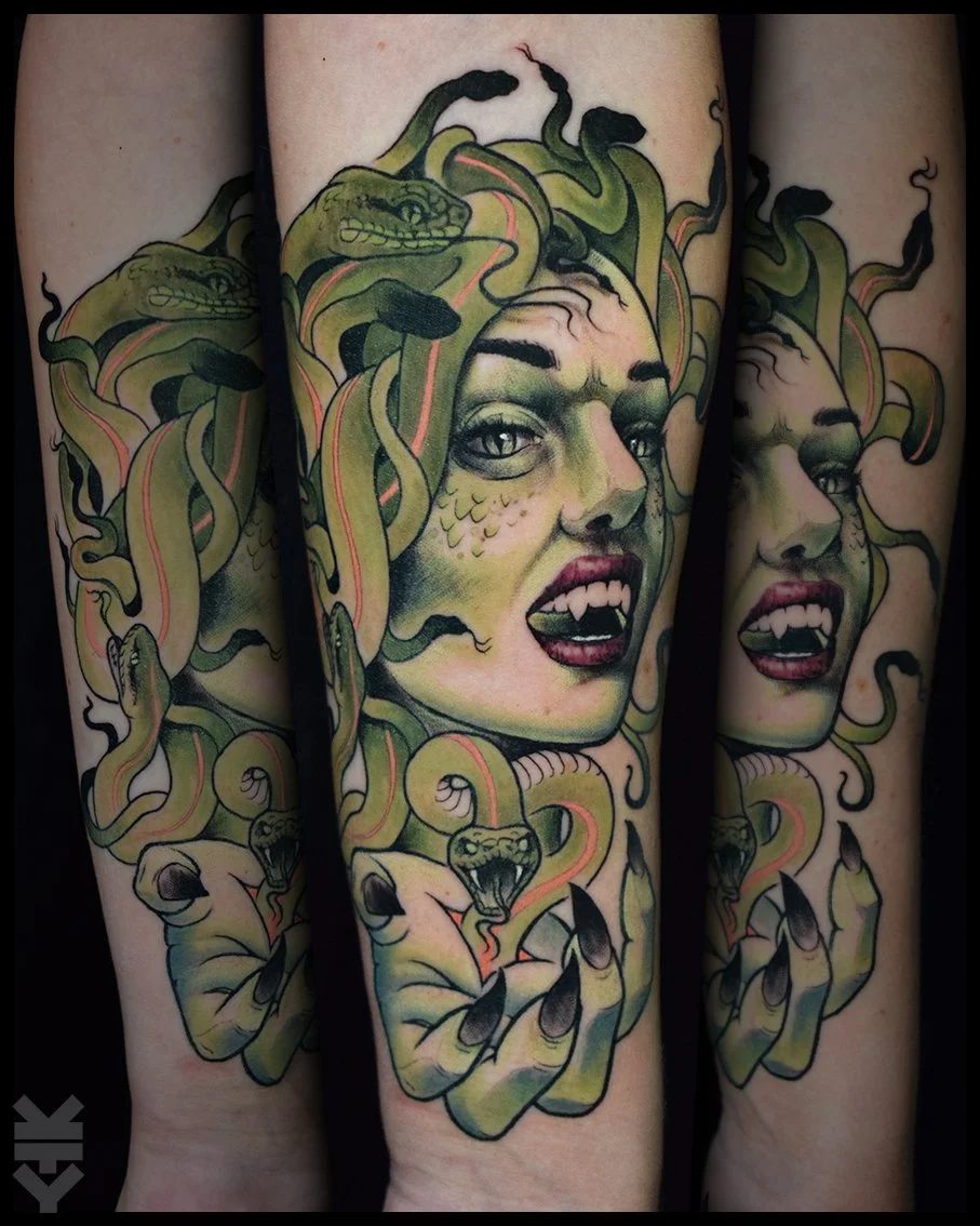 Tattoo of a woman with snake-like hair, green eyes, and an expressive face, with snakes and claws incorporated into the design.