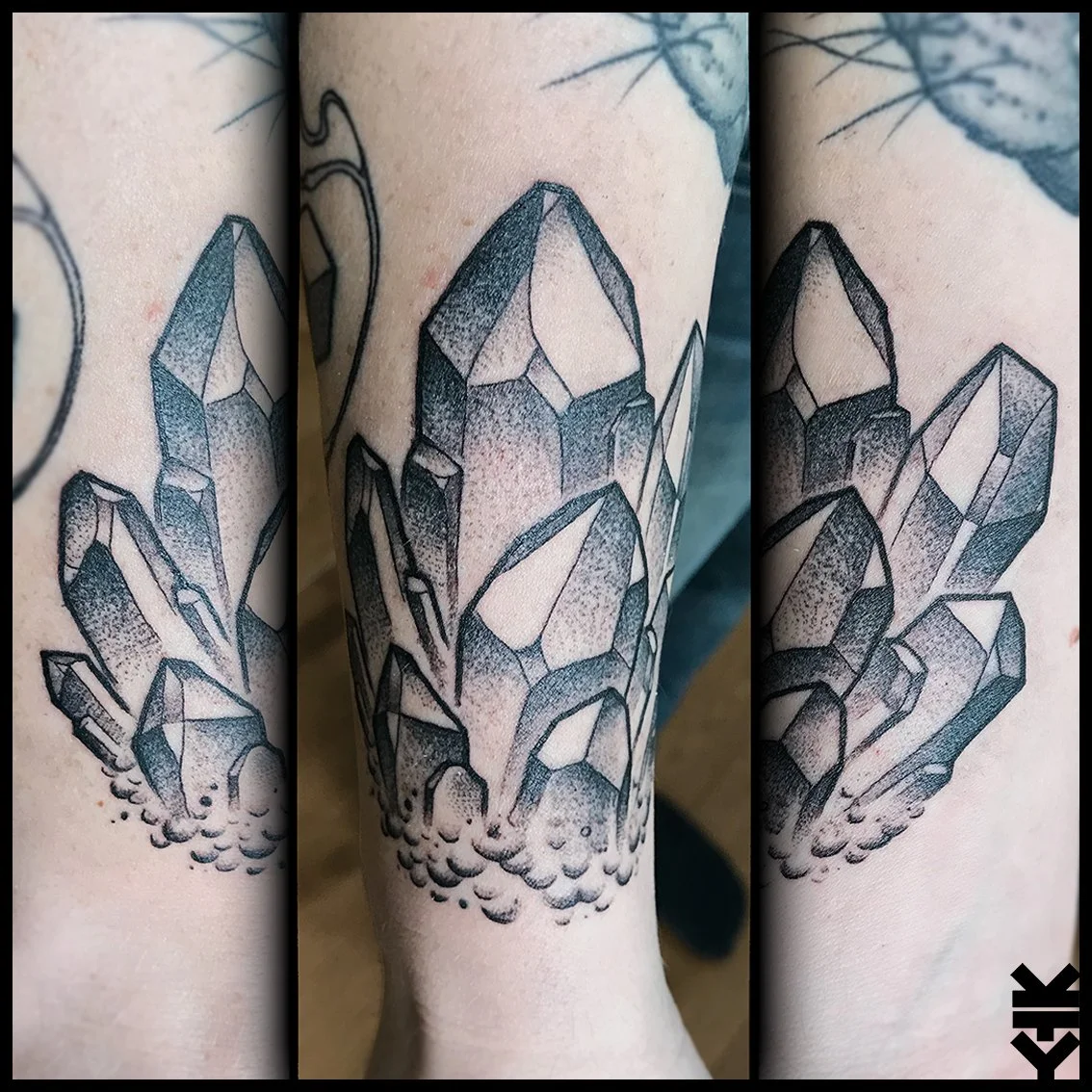 Black ink tattoo of multiple crystals with shading details, surrounded by small bubbles.