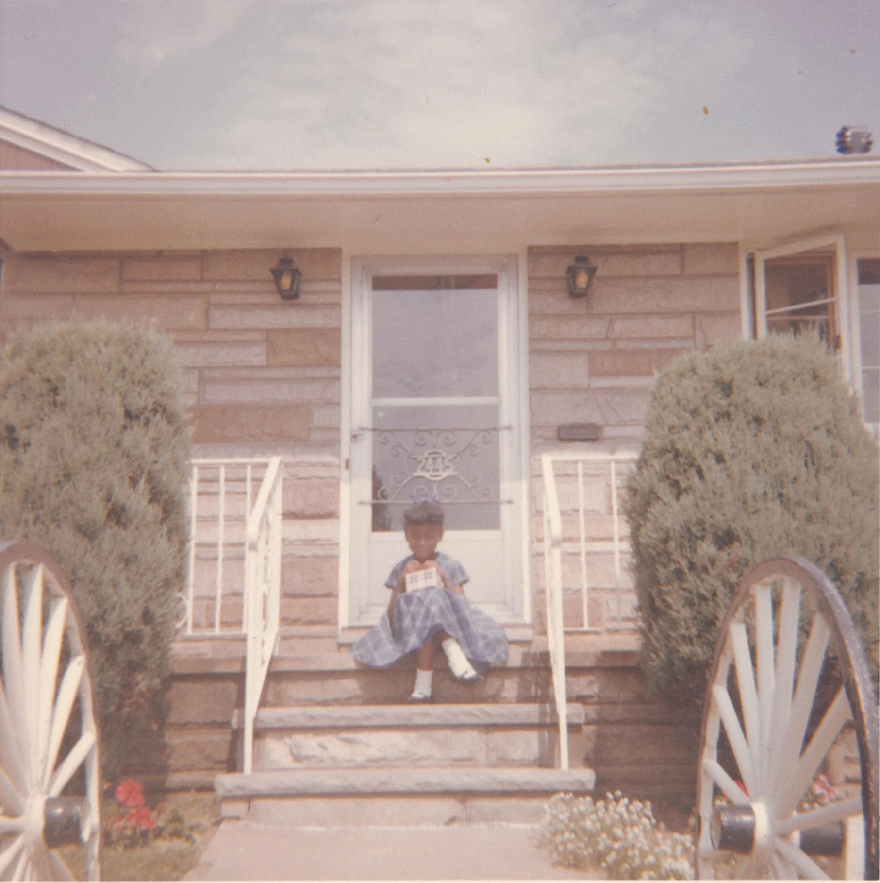 Kimberlé Crenshaw sitting on steps of a house