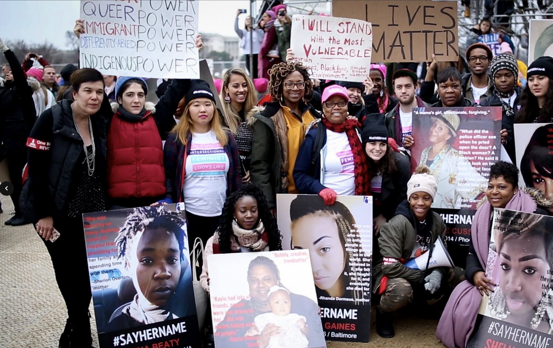 Women gathering/protesting with #SayHerName banners