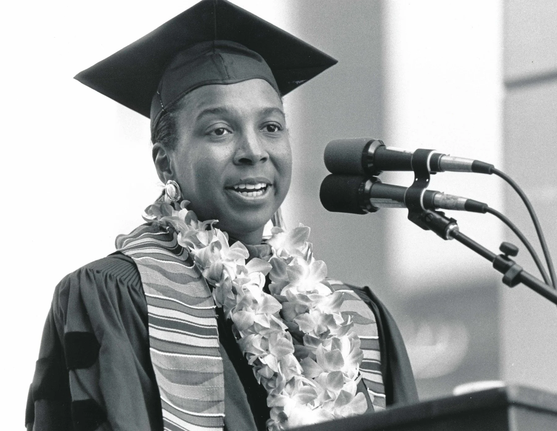 Kimberlé Williams Crenshaw in degree robes, speaking at a podium