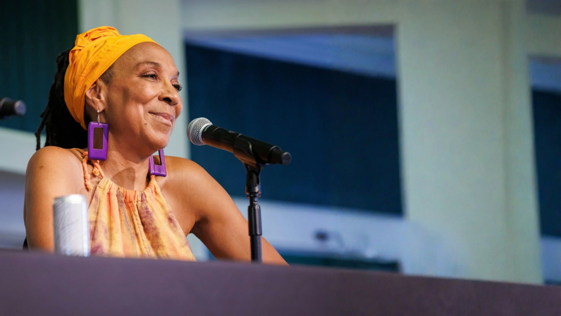 Kimberlé Williams Crenshaw, seated at a microphone, smiling
