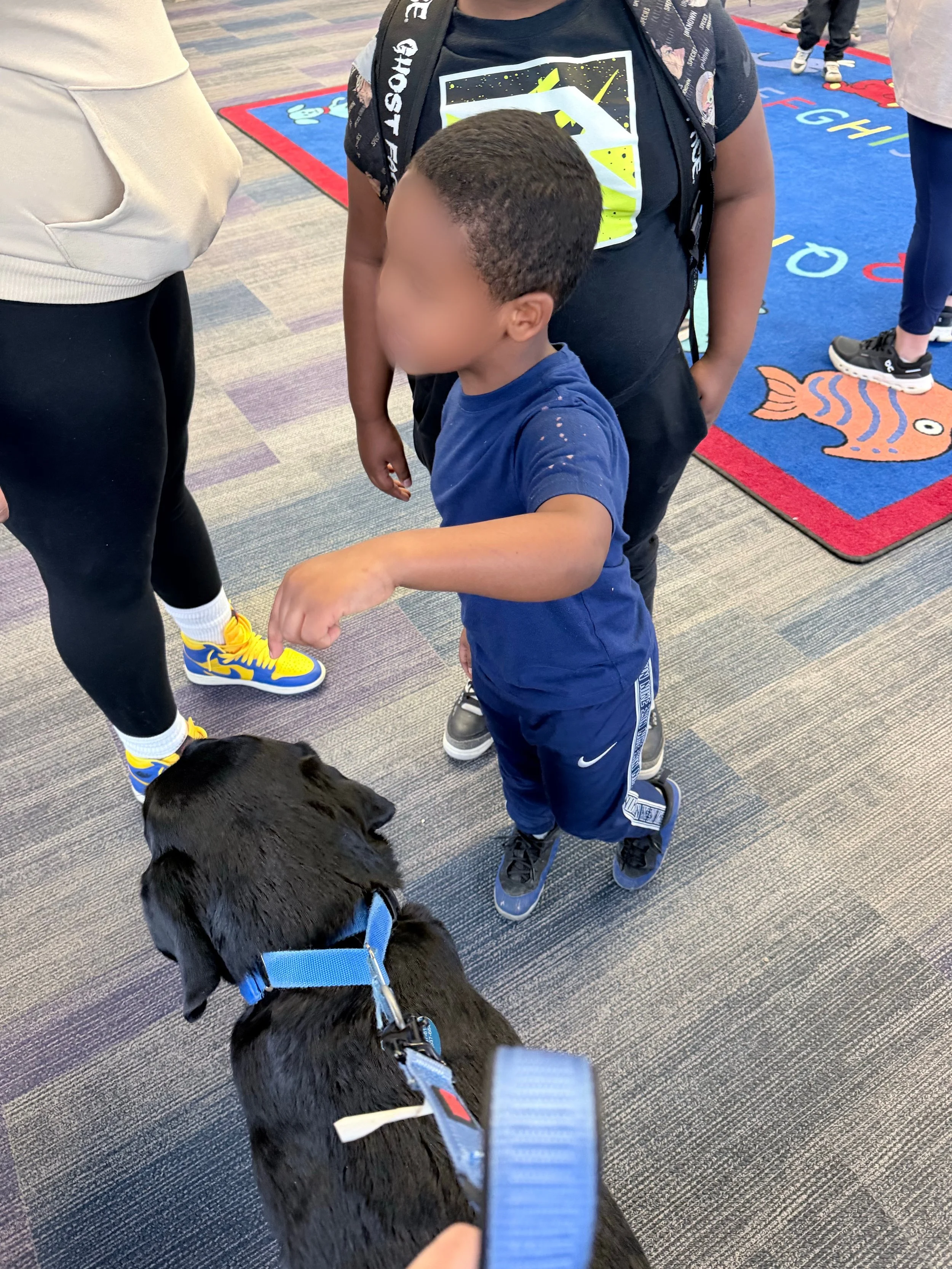 Let's "Paws" and Read Together - Annual interactive family reading night as 'One Book, One School' celebration kicks off in honor of a beloved teacher who shares her love of reading and dogs with the school.