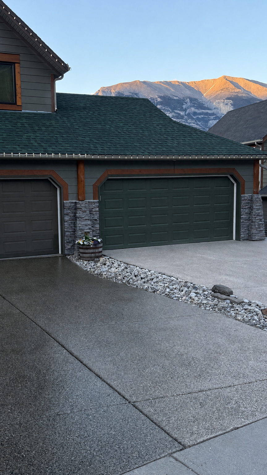 Driveway resealing in Canmore, Alberta, showing the restoration and sealing of an exposed aggregate concrete driveway.