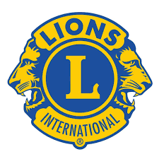 Lions Club International logo featuring a blue circle with a yellow border, the letter 'L' in the center, and two lion profiles facing outward on either side, with the words 'Lions' and 'International'.
