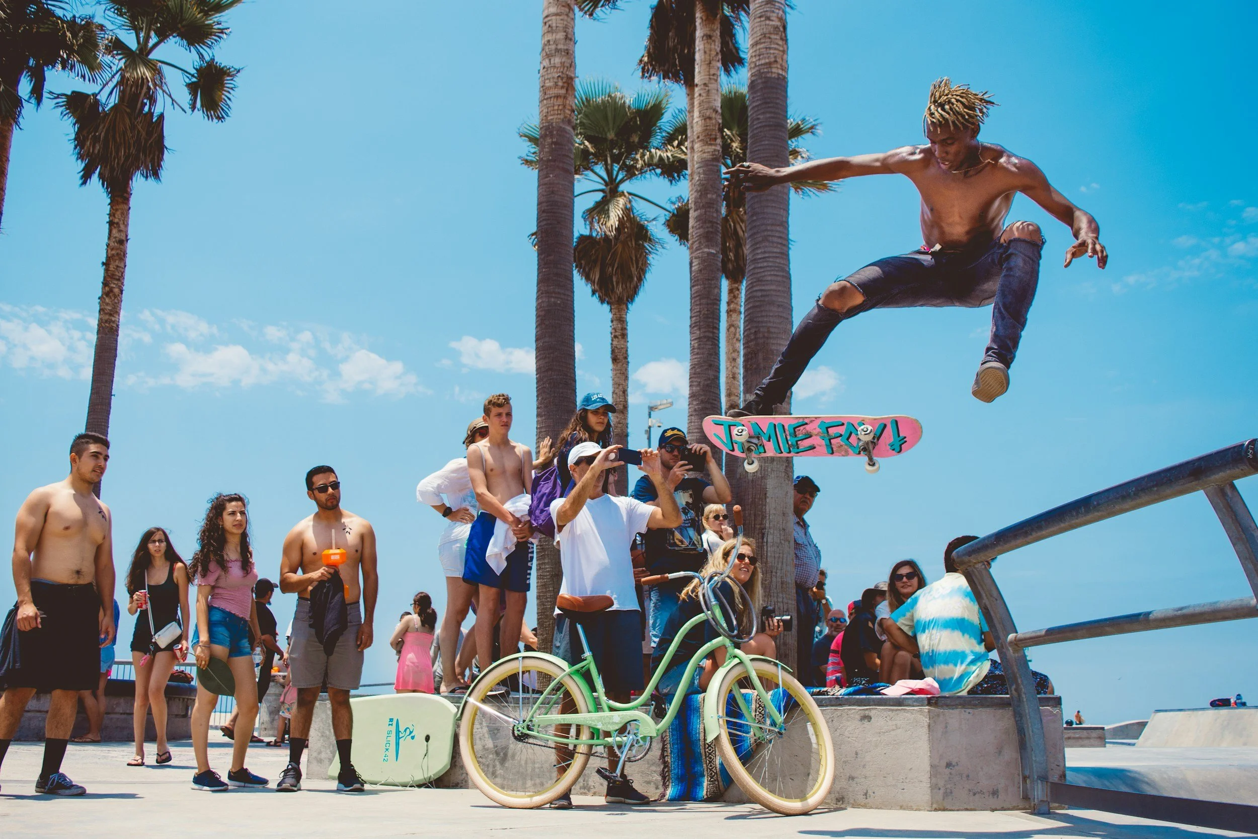 skateboarder at venice beach doing a trick