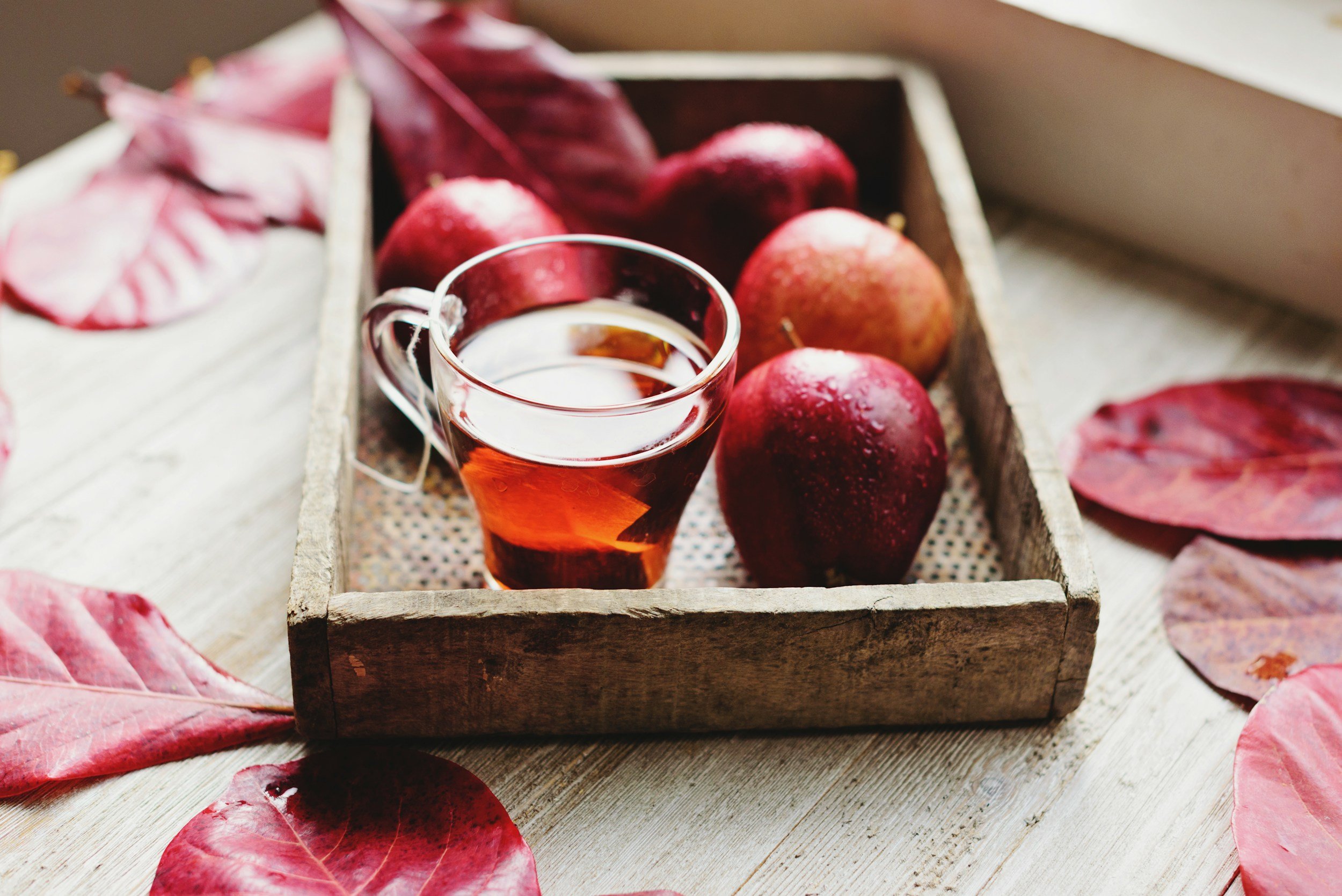 cider and apples on a tray