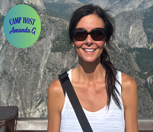 A smiling woman with dark hair and sunglasses standing outdoors with mountains in the background. There is a green circular badge in the top left corner with blue text reading 'CAMP HOST Amanda G'.