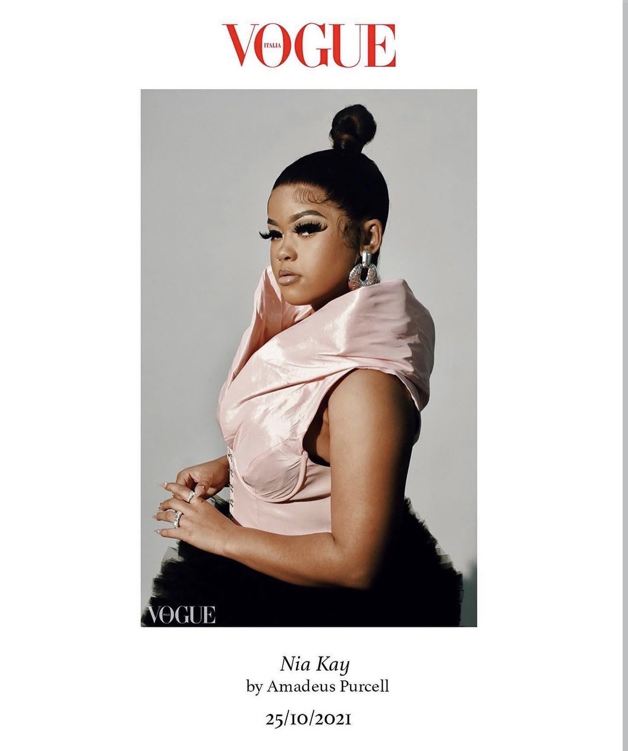 Vogue magazine cover featuring Nia Kay in a pink satin dress with large earrings, styled with a high bun, dated October 25, 2021.