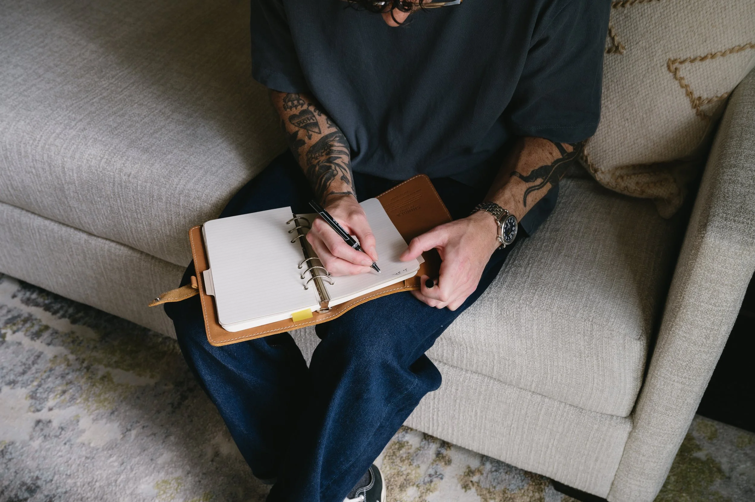 Josh Shifrin writing notes on a notepad.