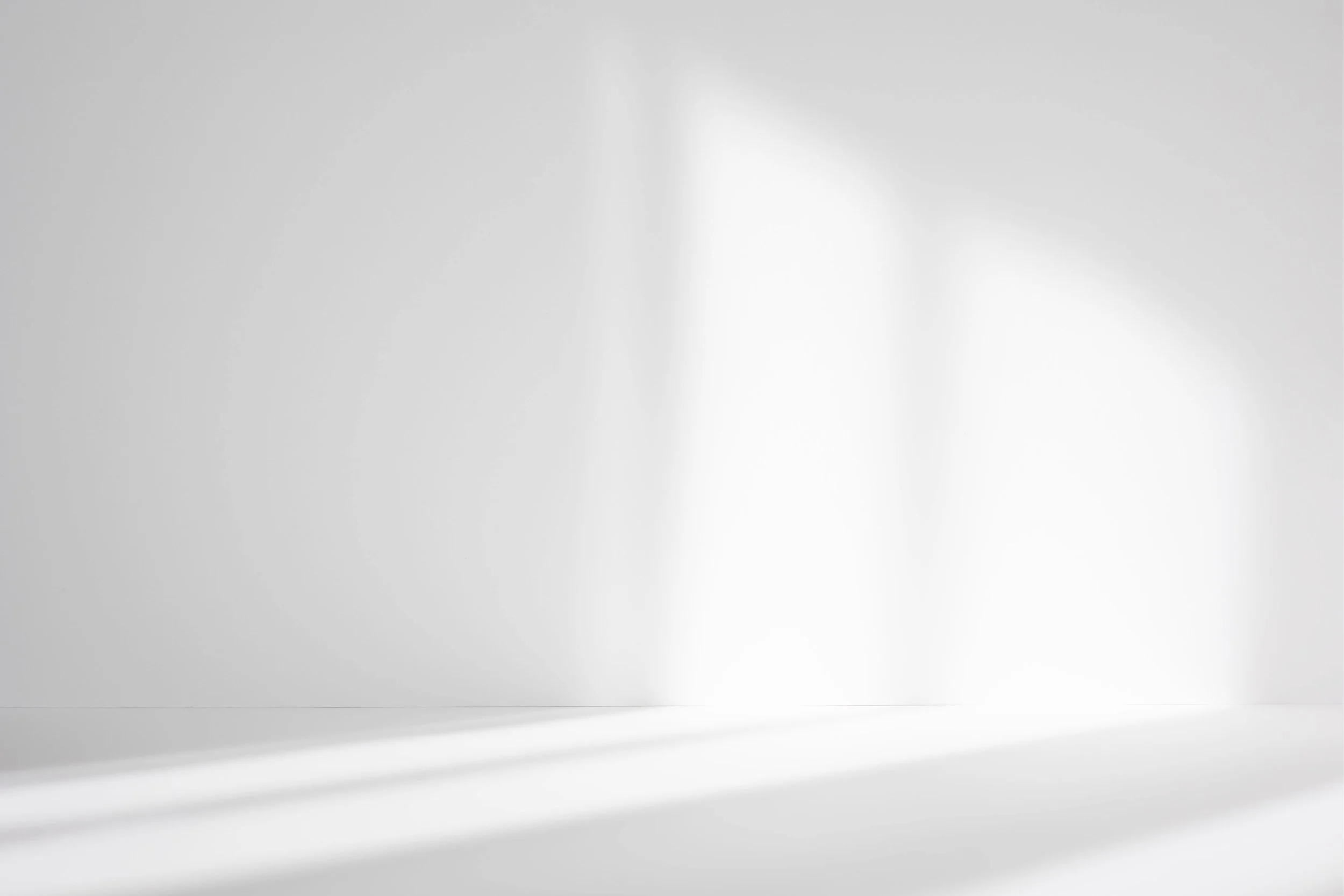 Bright, minimal white room with soft shadows, used to represent Internal Family Systems (IFS) therapy.