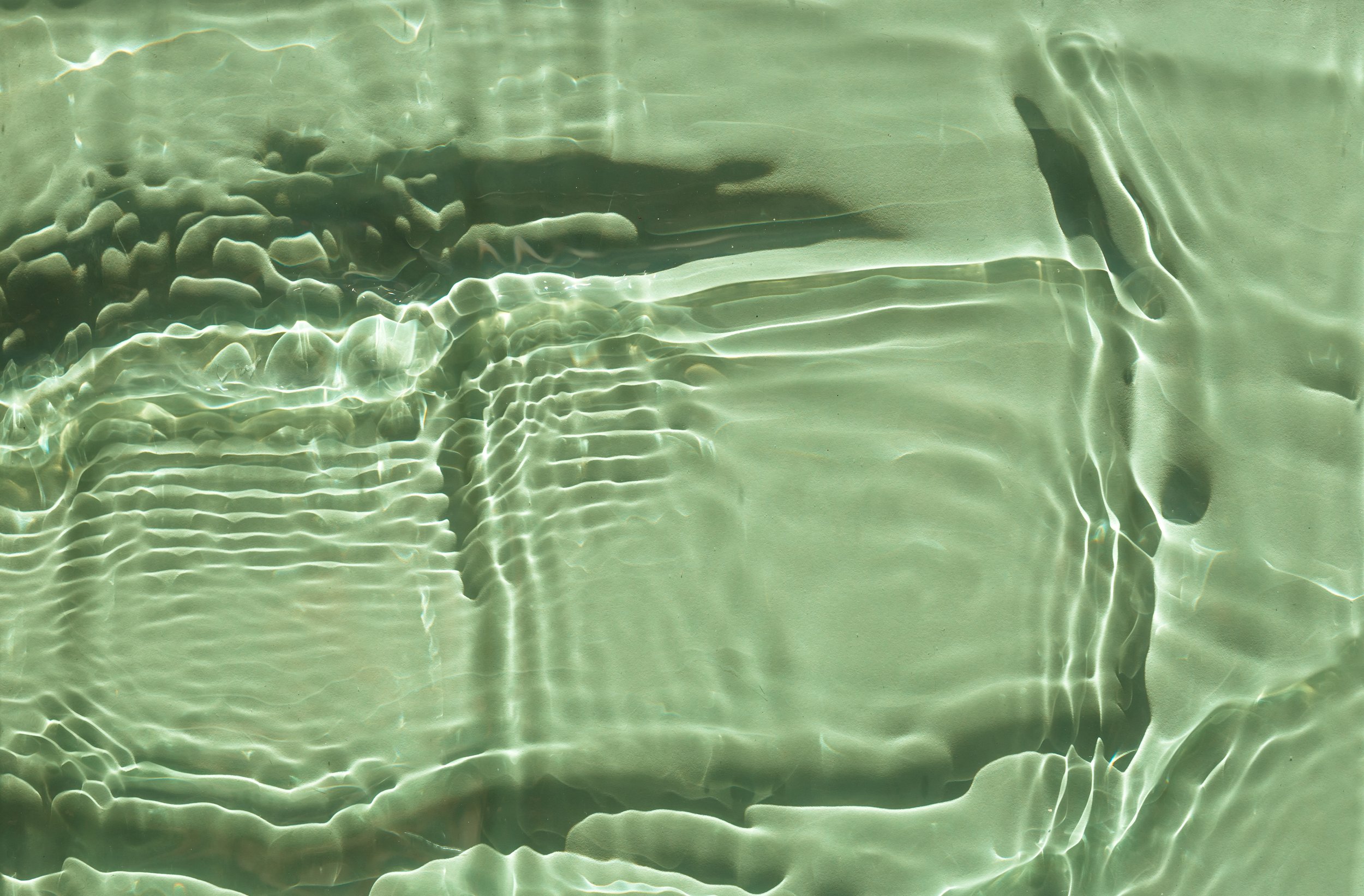 Ripples in a pool, used as a calm accent image.
