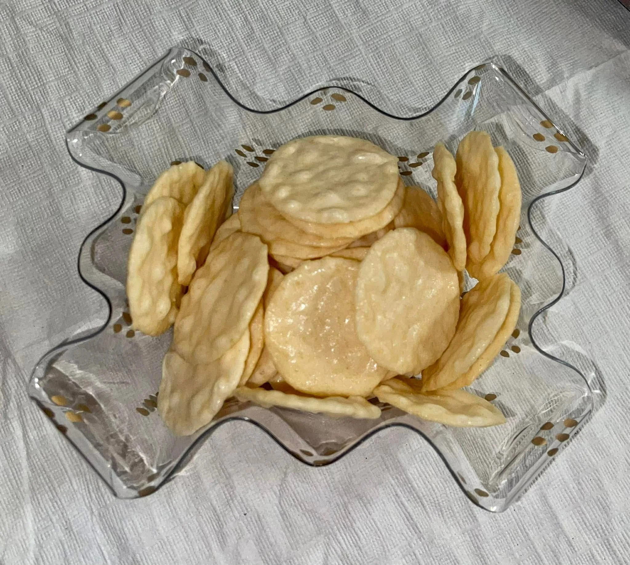 Overhead view of rice crackers in decorative glass dish