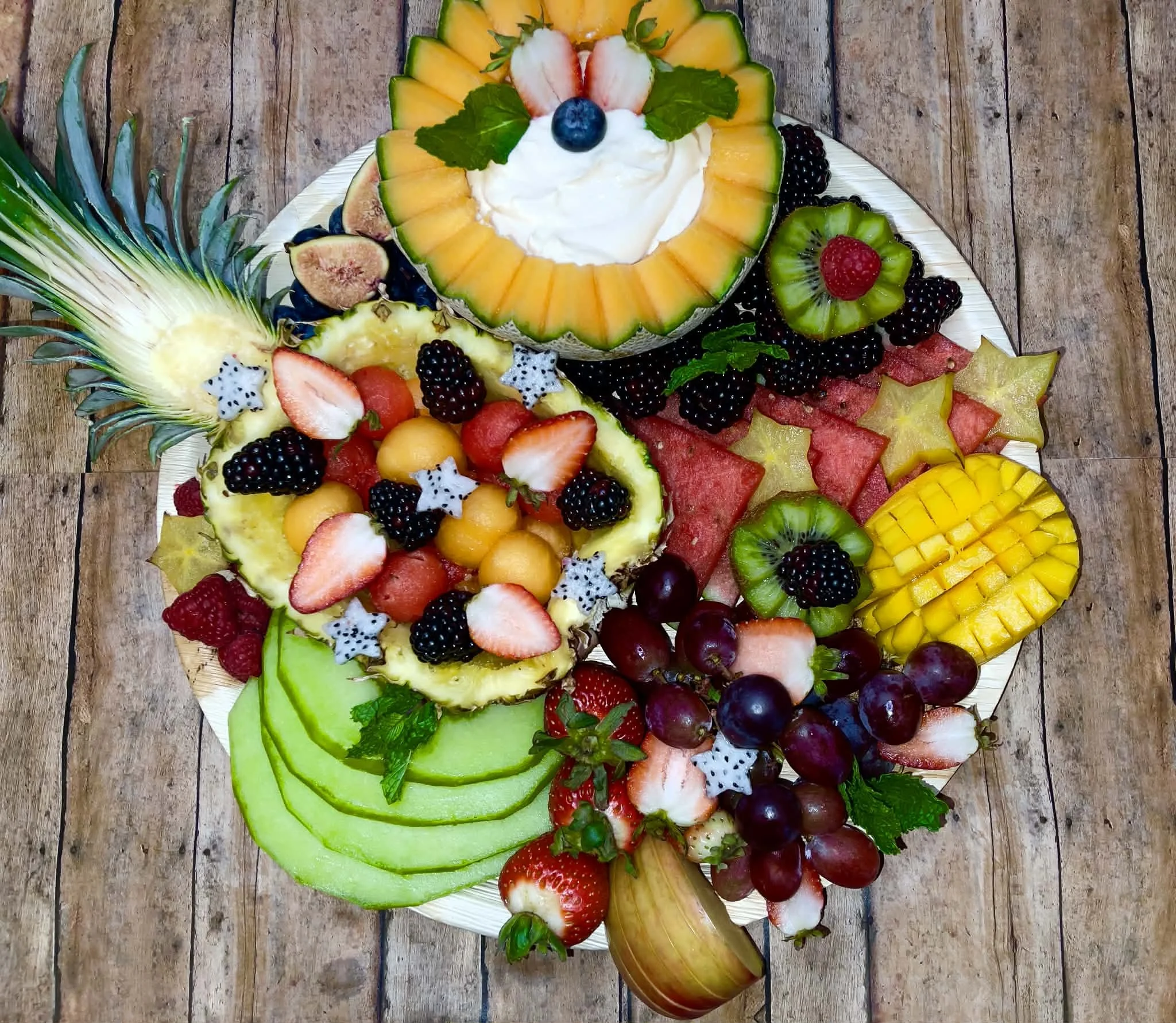 Spread of seasonal fruit and yogurt dip inside a cored out fruit.