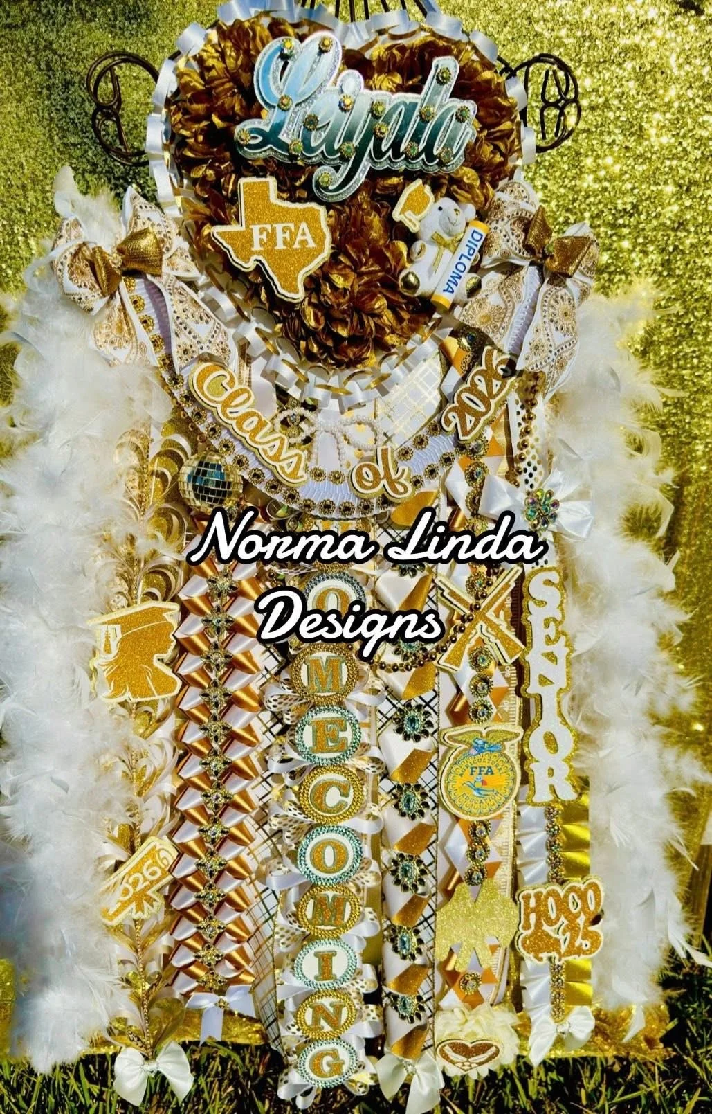 Gold and white mum featuring Texas theme, ribbons, feather boa and custom name plate