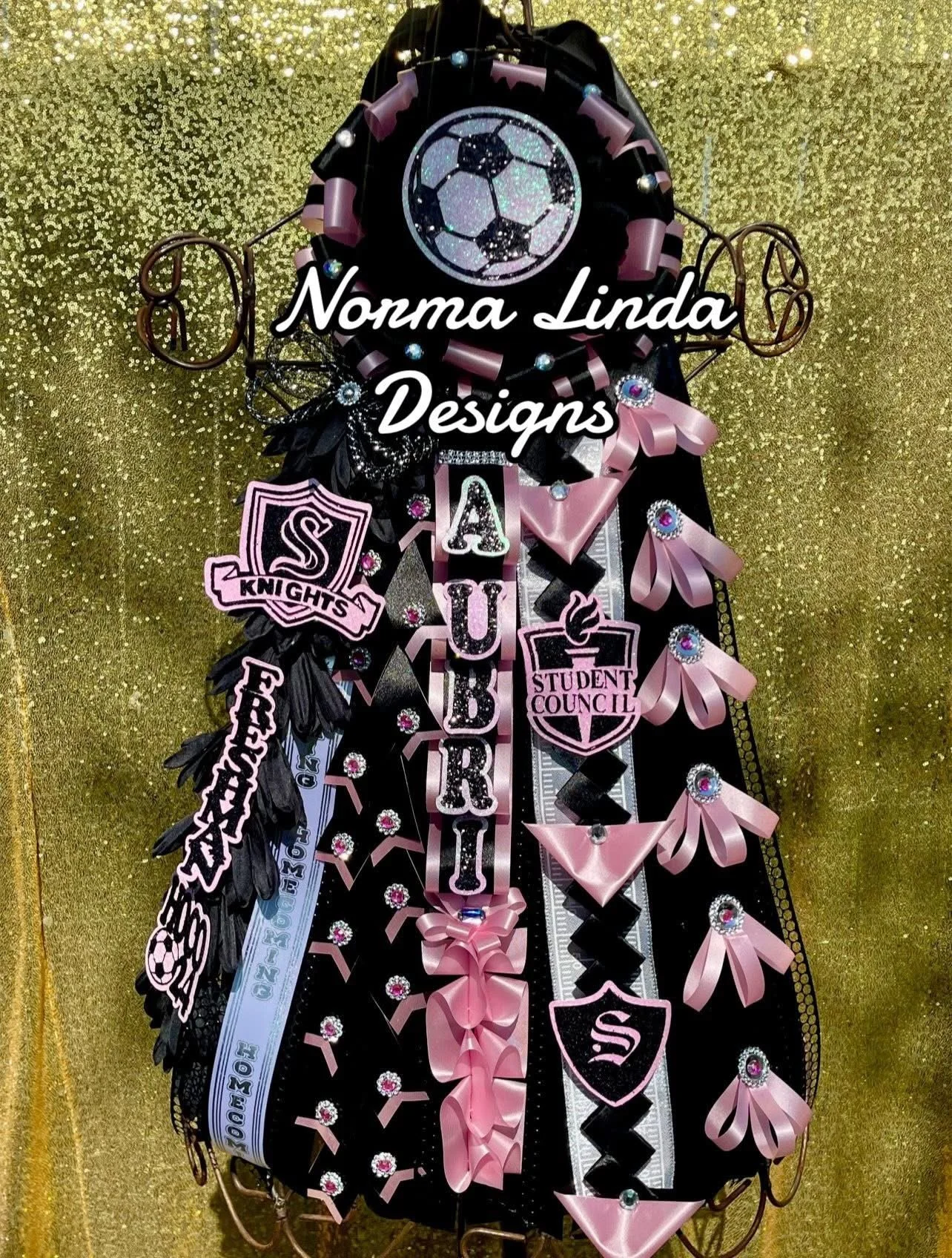 Soccer theme black and pink mum featuring black ribbons, pink ribbons and bows