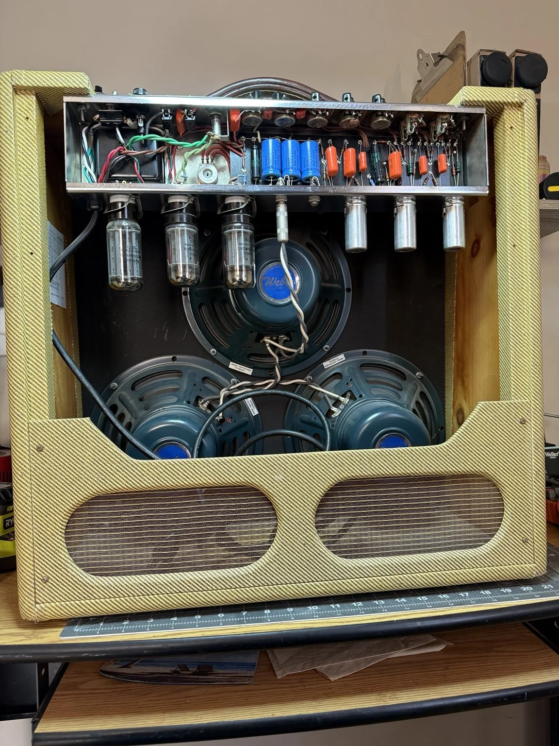 Rear view of a Wright Bandmaster amplifier with its chassis and speakers exposed during servicing.