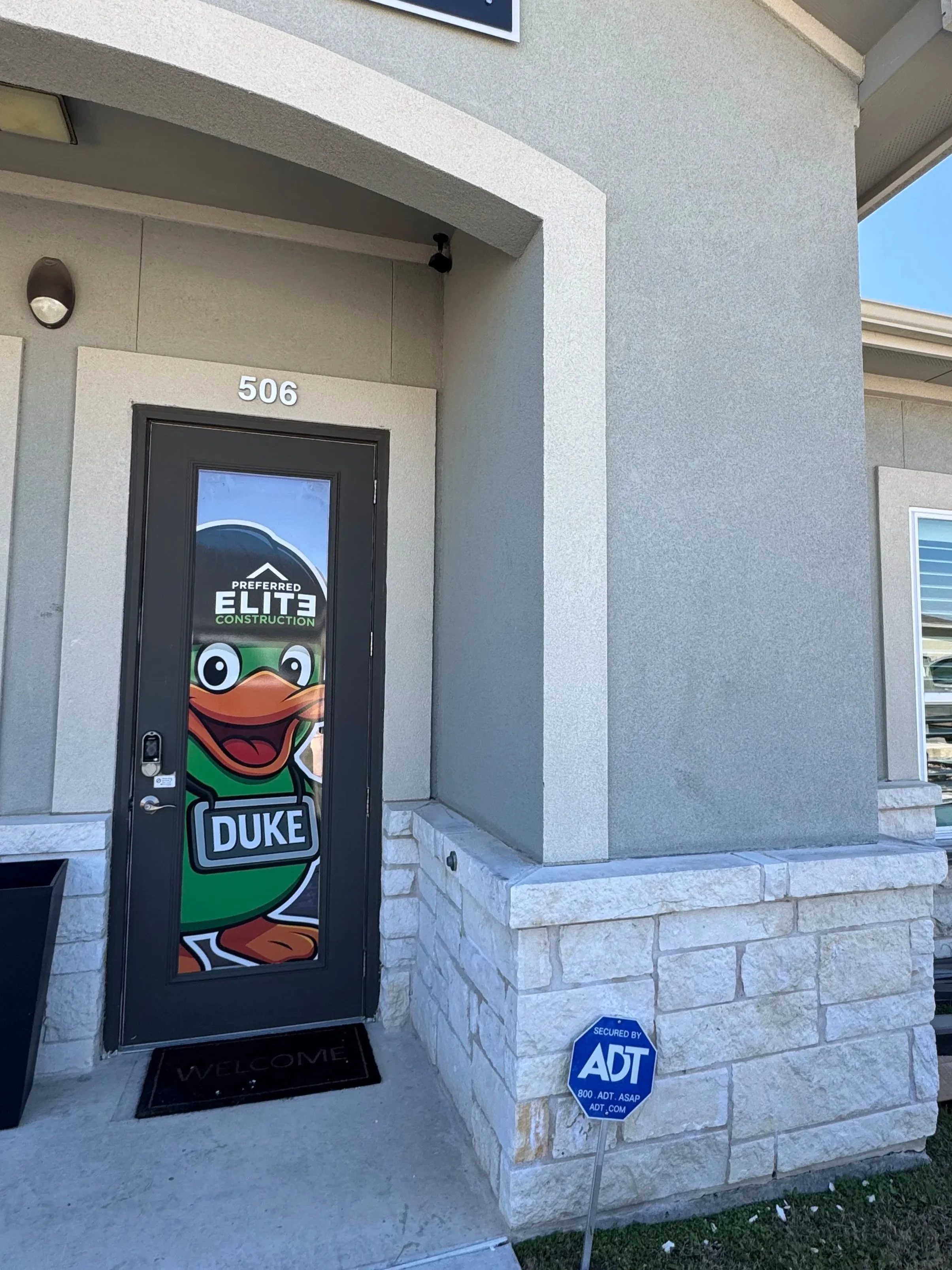 local roofing company office in Leander Texas Preferred Elite Construction with Duke mascot branding