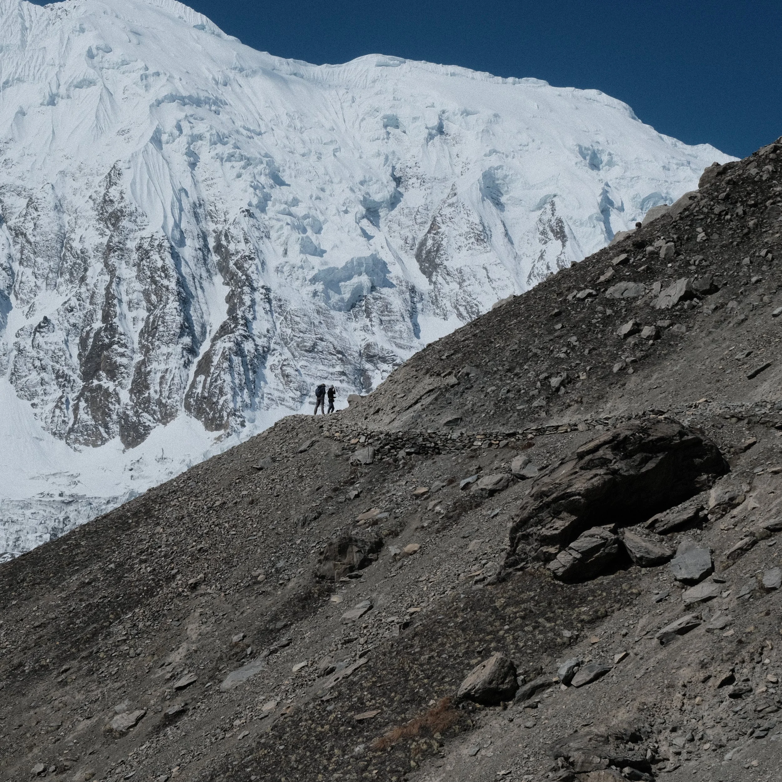 Personas en el Circuito de Annapurna con los Himalayas al fondo