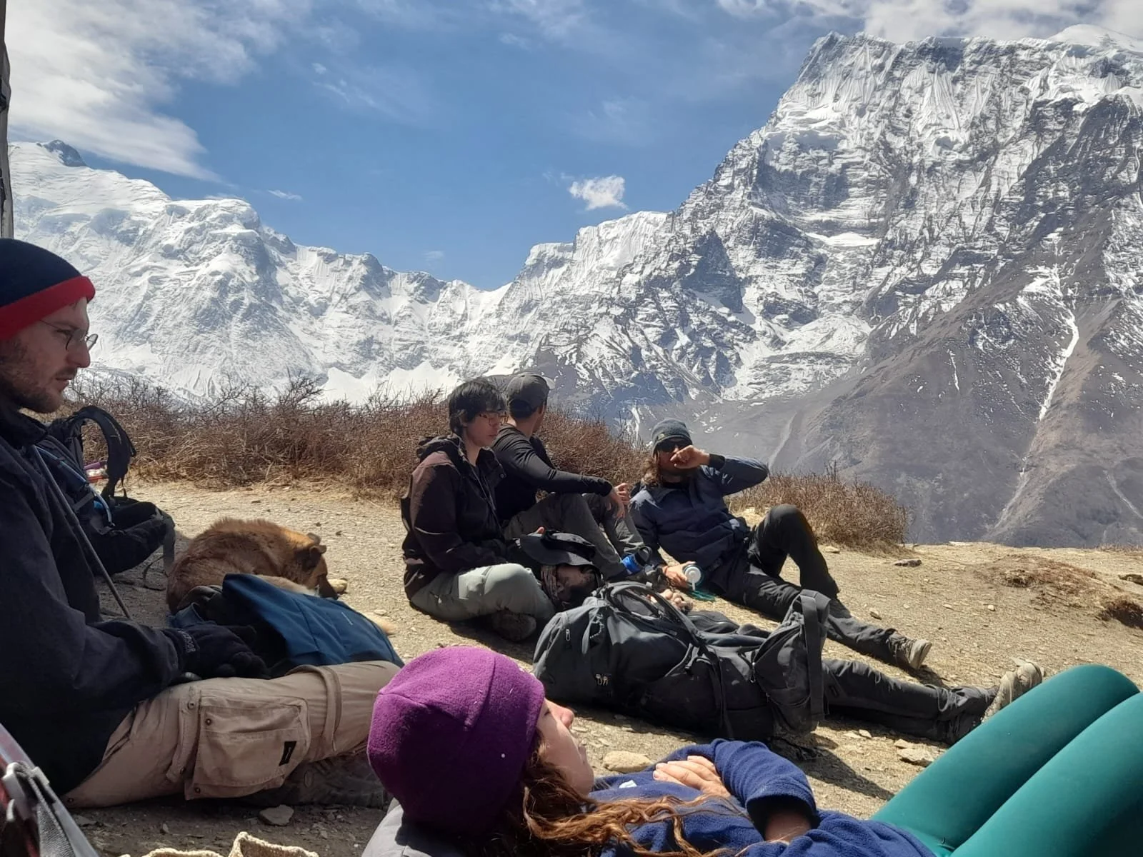 Personas descansando con himalayas al fondo en el Circuito de Annapurna