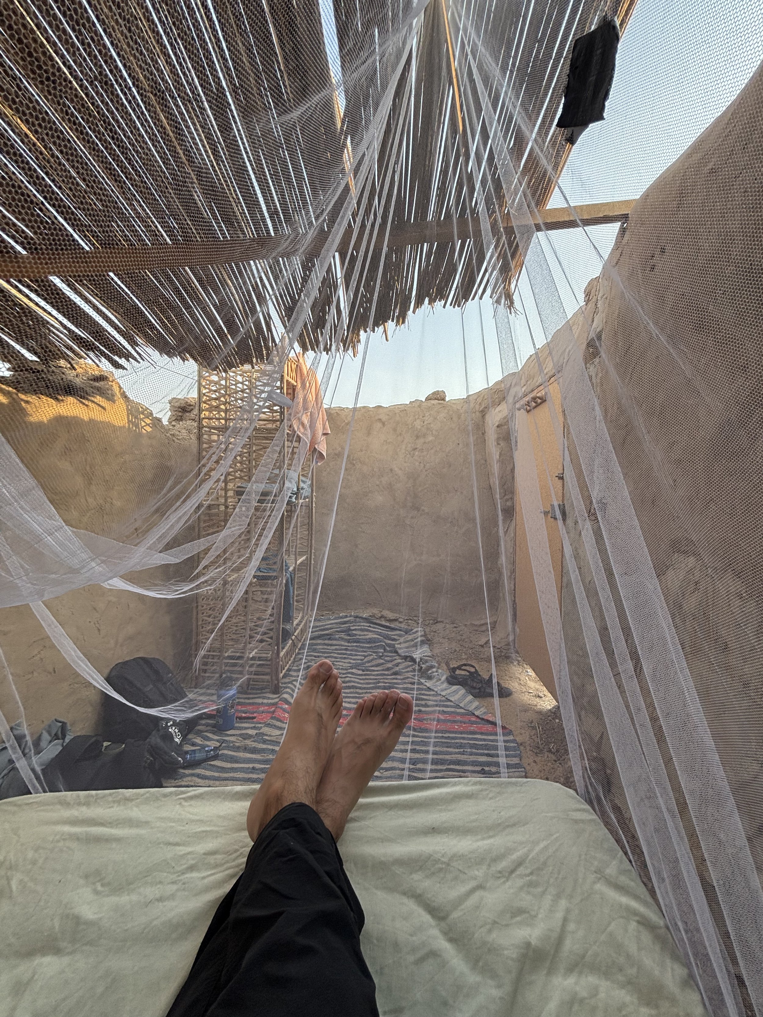Foto de una cama en habitación de barro, con mosquitero en Egipto.
