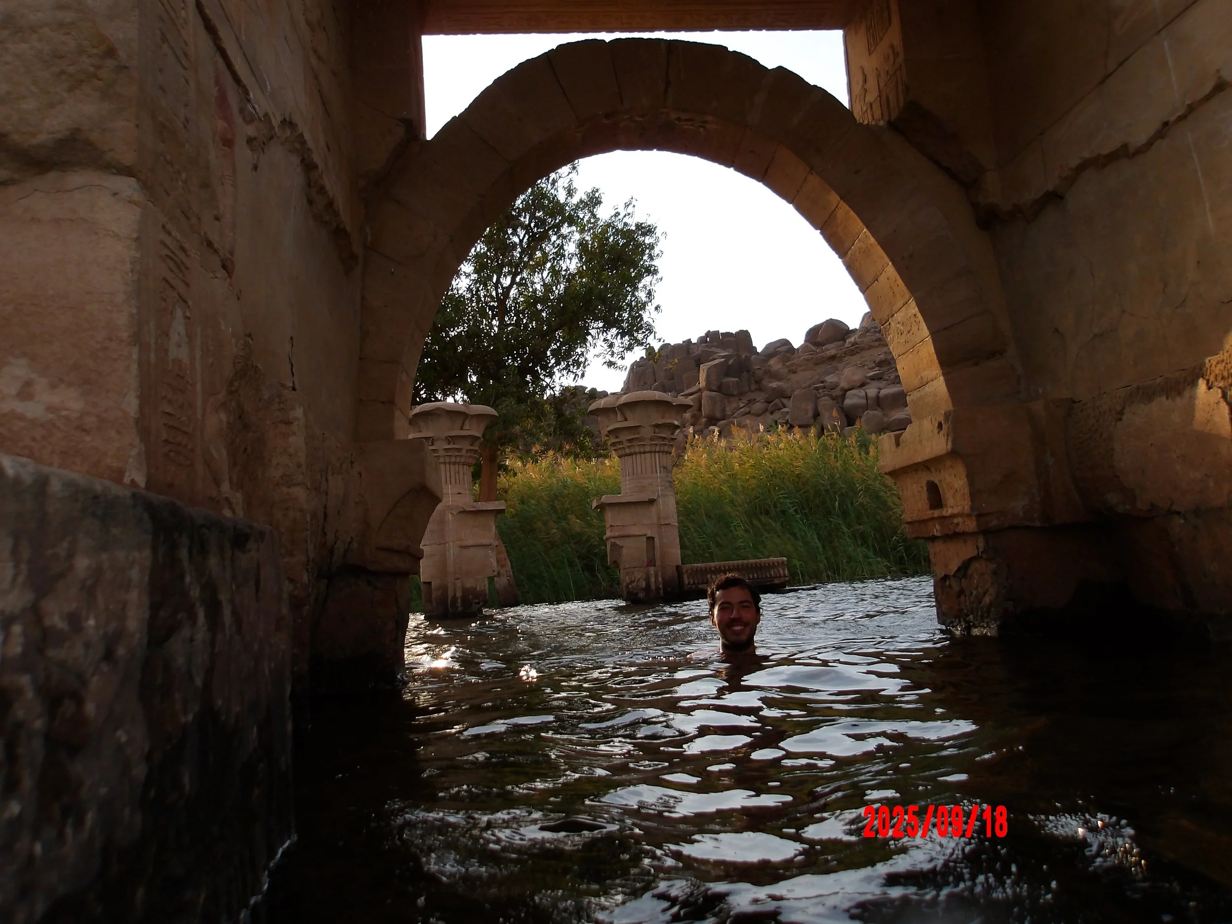 Persona nadando en el Nilo, junto a un templo egipcio.