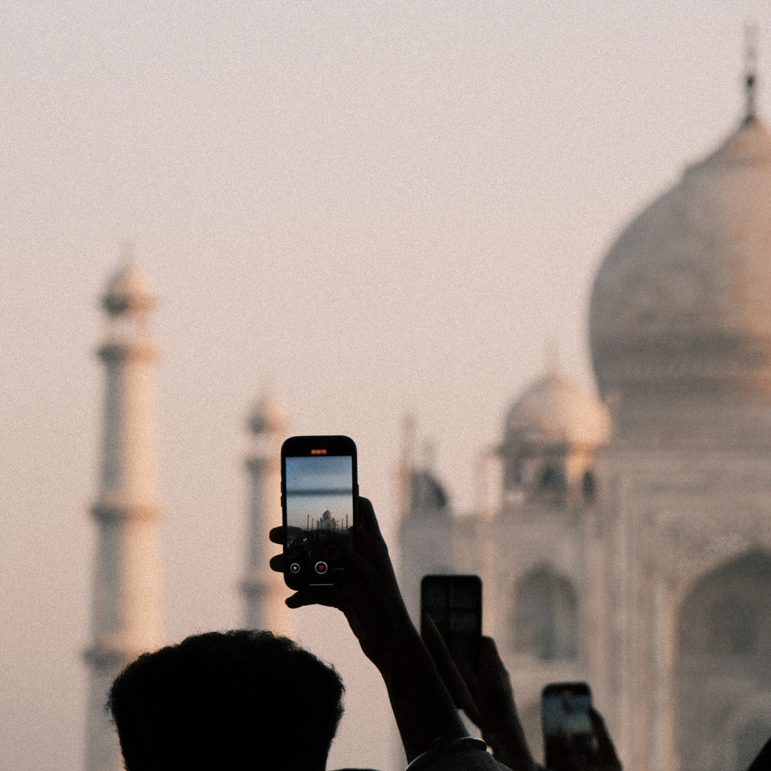Persona tomando foto del Taj Mahal con el celular