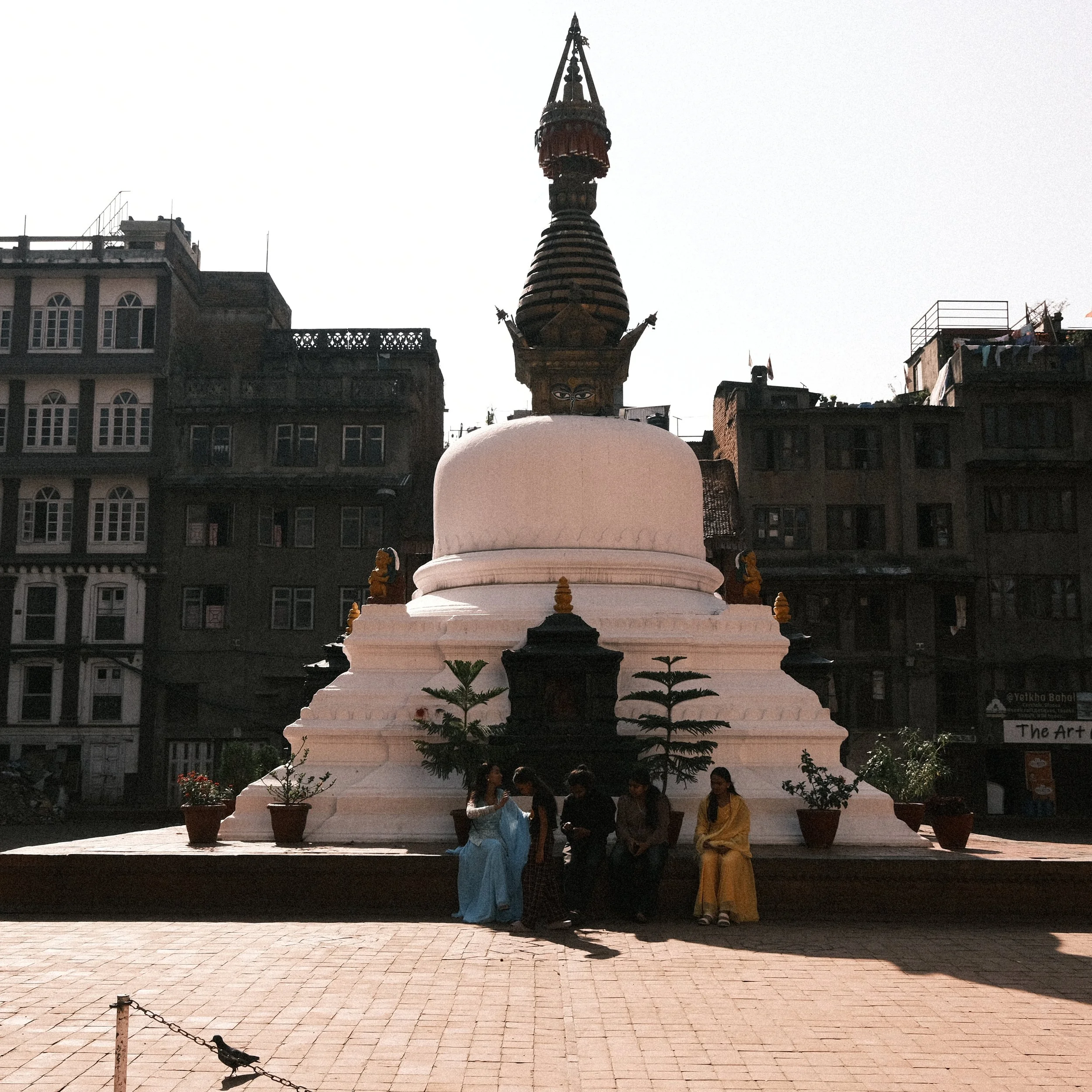 Personas sentadas en una estupa en el centro de Katmandú