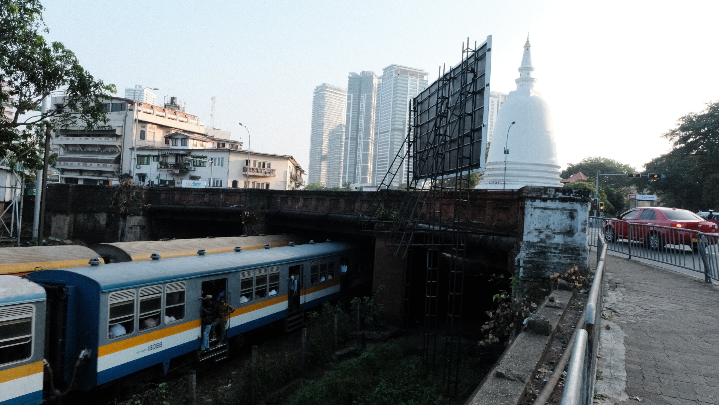 Foto de tren pasando debajo de un puente en Colombo Sri Lanka