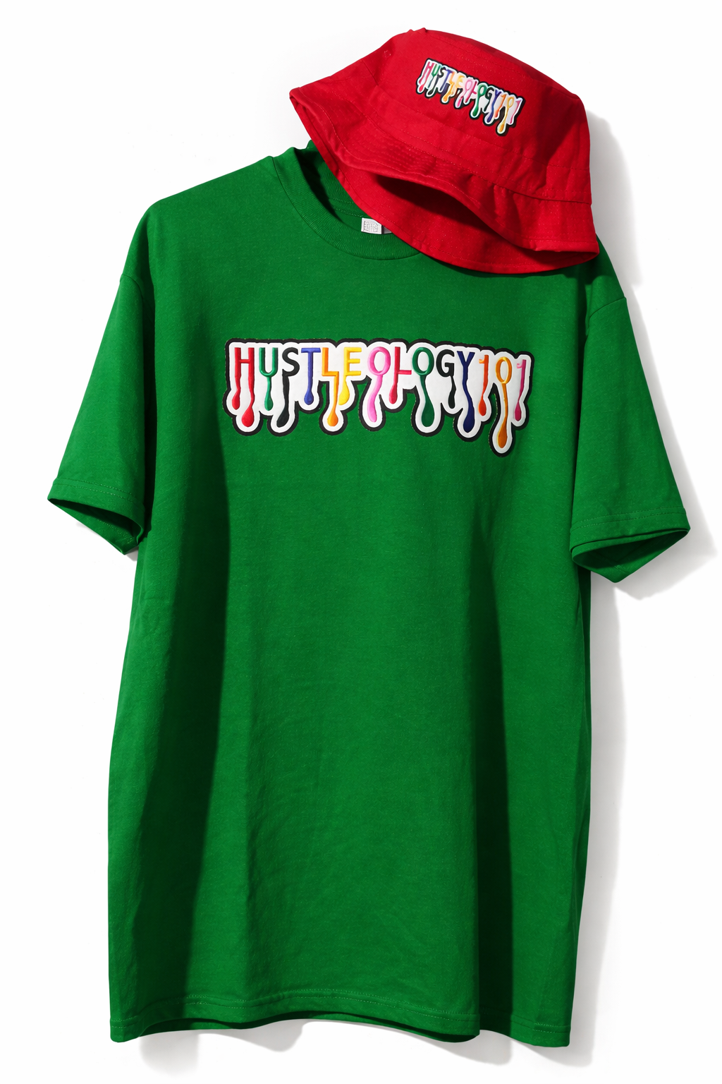 Green t-shirt with colorful 'HUSTLELOGY' graphic patch and a matching red bucket hat with the same design.