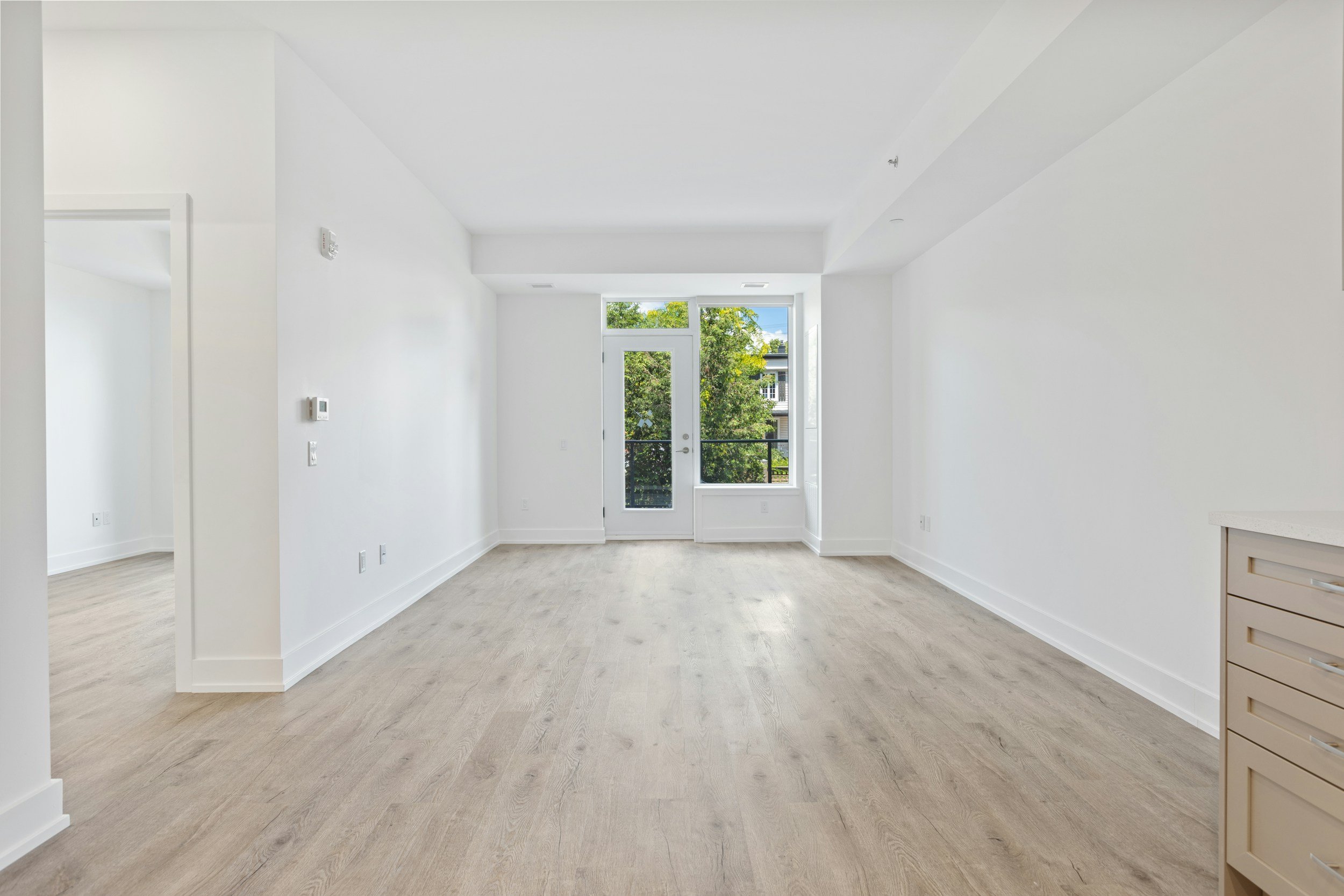 Clean empty apartment unit with hardwood floors ready for new tenant, prepared by True Wave property management cleaning services