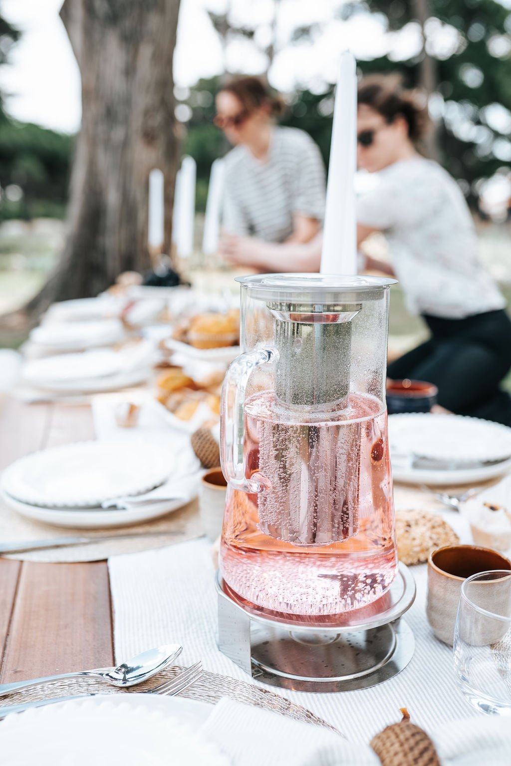 Beautifully styled outdoor picnic setting with refreshments, premium tableware, and luxury picnic décor in a Melbourne park location.
