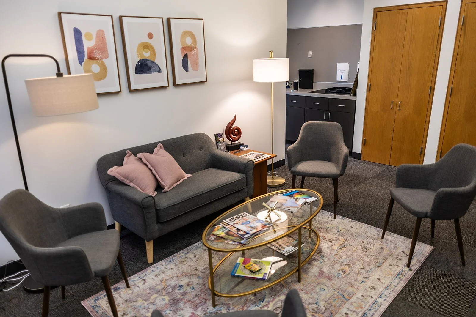 Cozy therapy waiting room with pink chair representing welcoming perinatal trauma therapy St. Paul