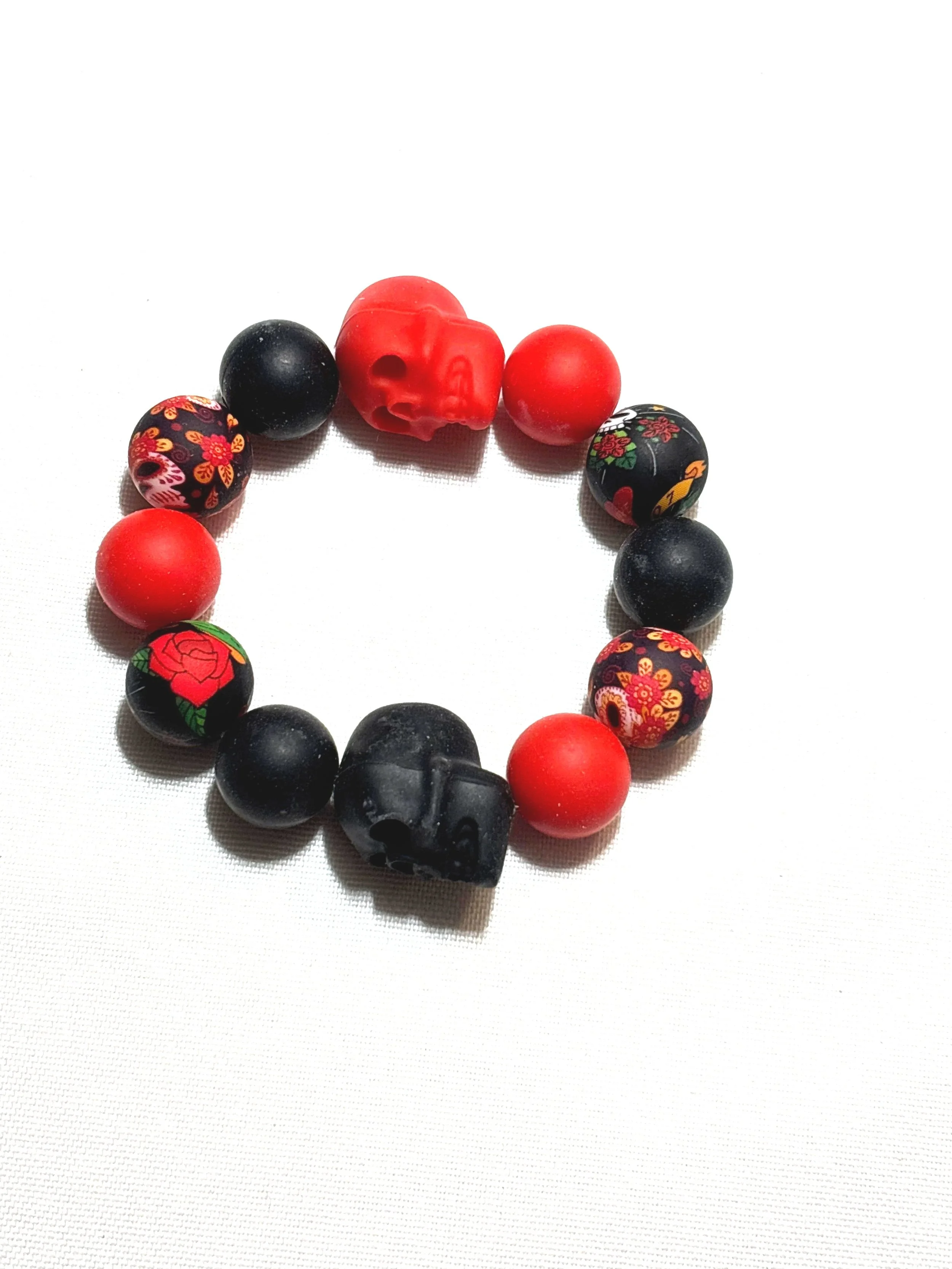 Fun black and red rubber beads with skulls