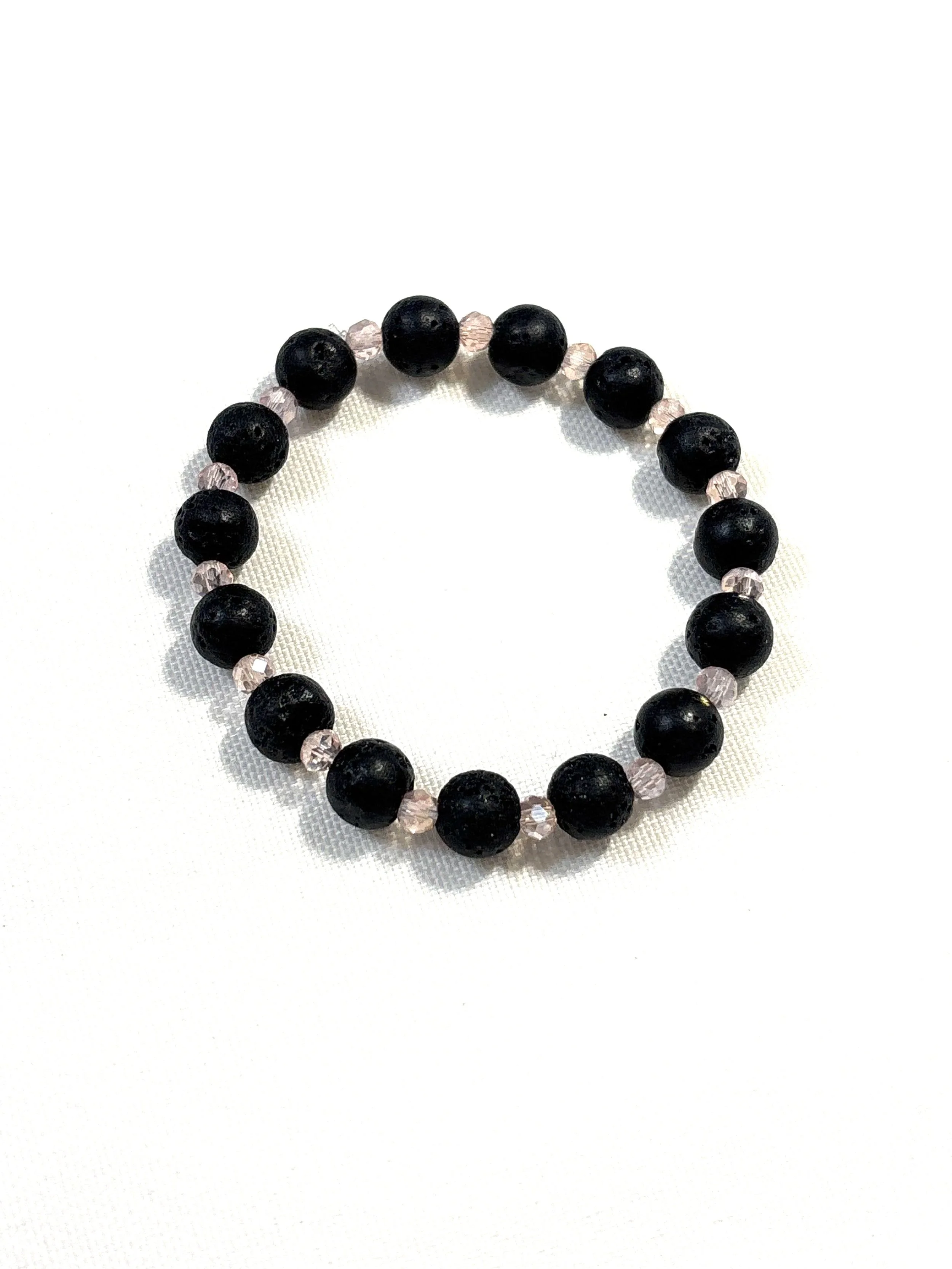 Lava bead with with small crystal