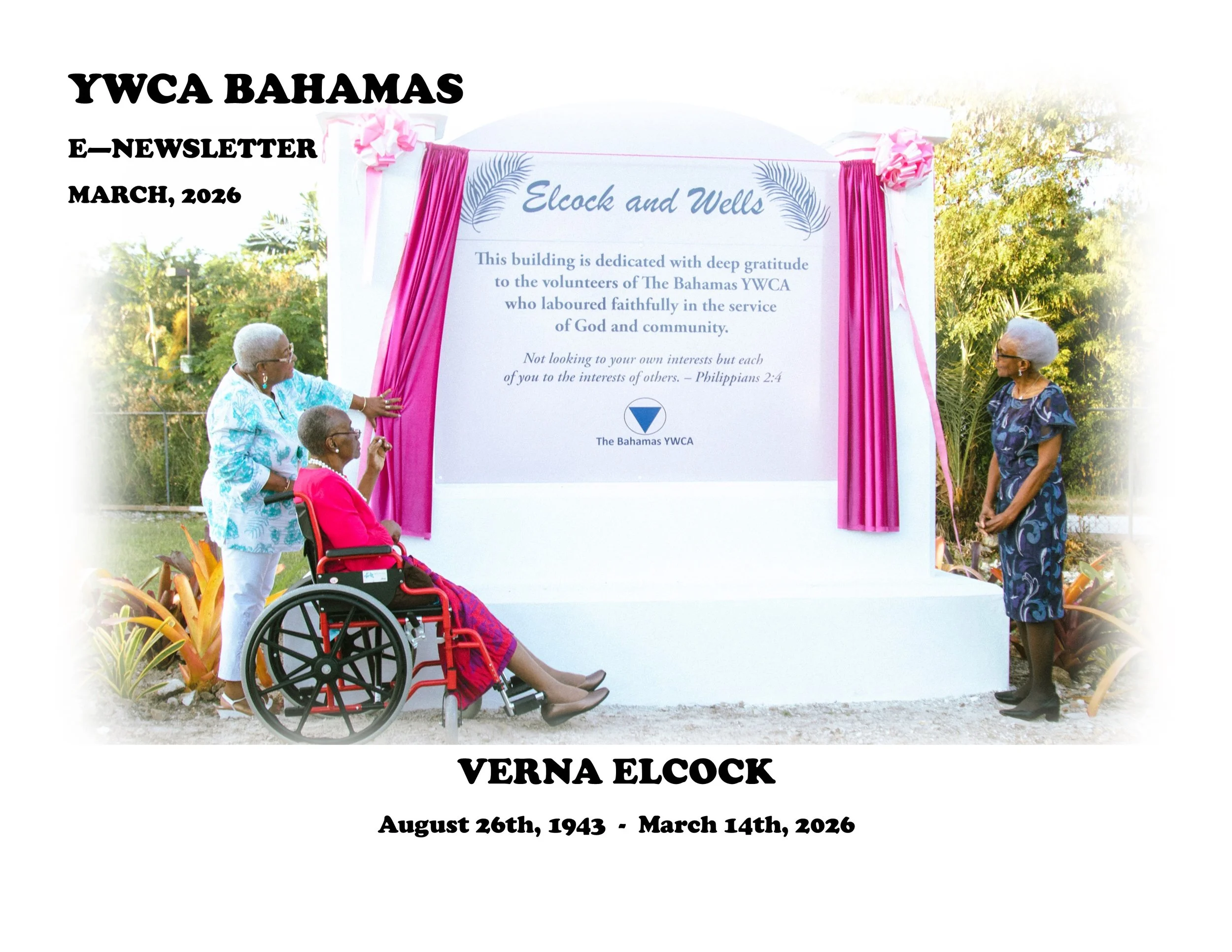 Three women unveiling a memorial plaque dedicated to Verna Elcock at YWCA Bahamas, with one woman in wheelchair and two standing, in an outdoor setting with greenery.