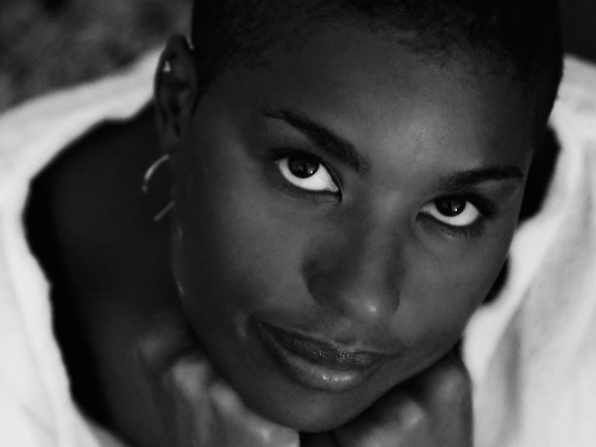 Close-up black-and-white photo of a person's face.