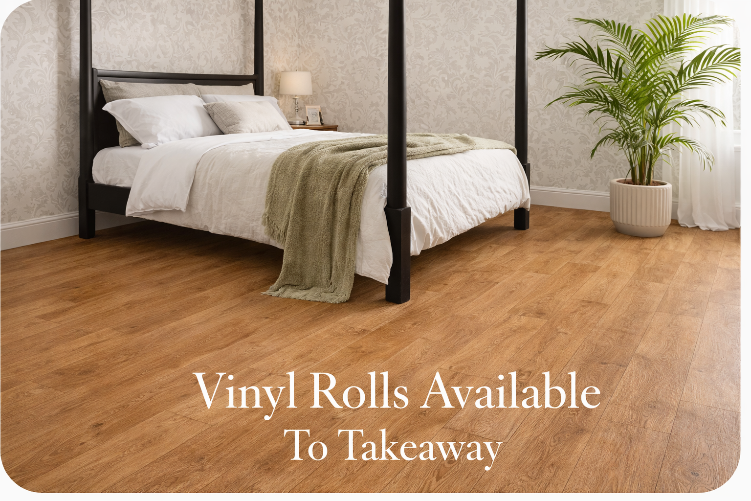 Oak effect vinyl flooring in a modern bedroom with four poster bed and vinyl rolls available to takeaway