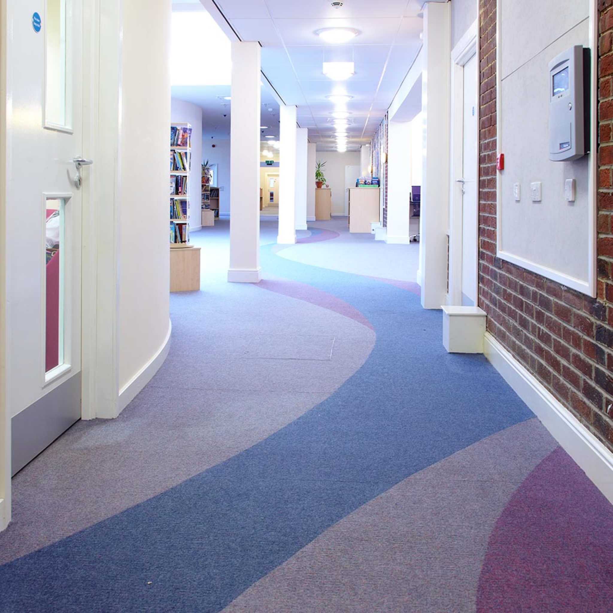 Commercial carpet tile flooring installed in a modern school corridor designed for high foot traffic in education buildings