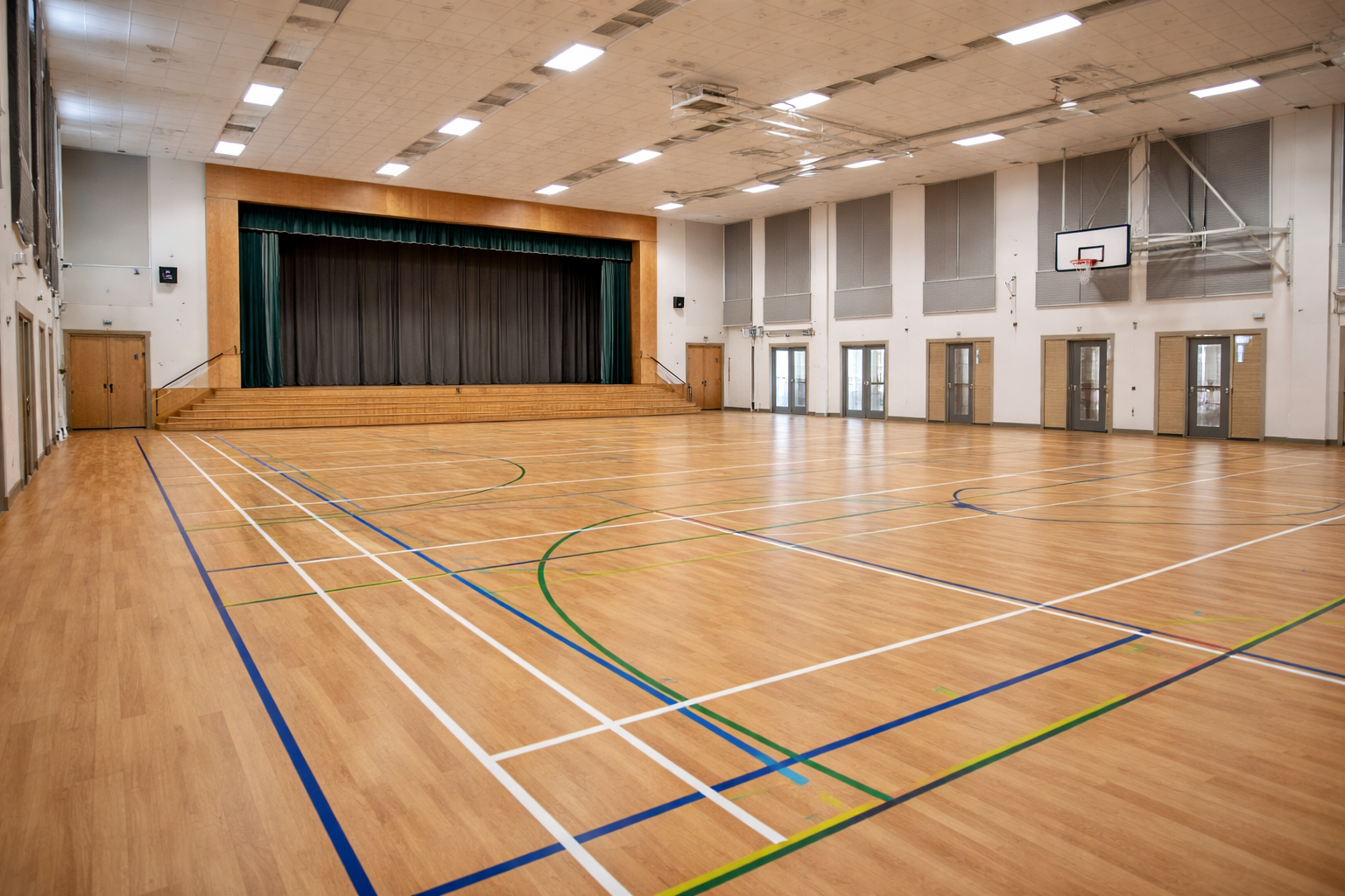 Large school assembly hall with durable wood effect sports vinyl flooring used for assemblies and indoor activities