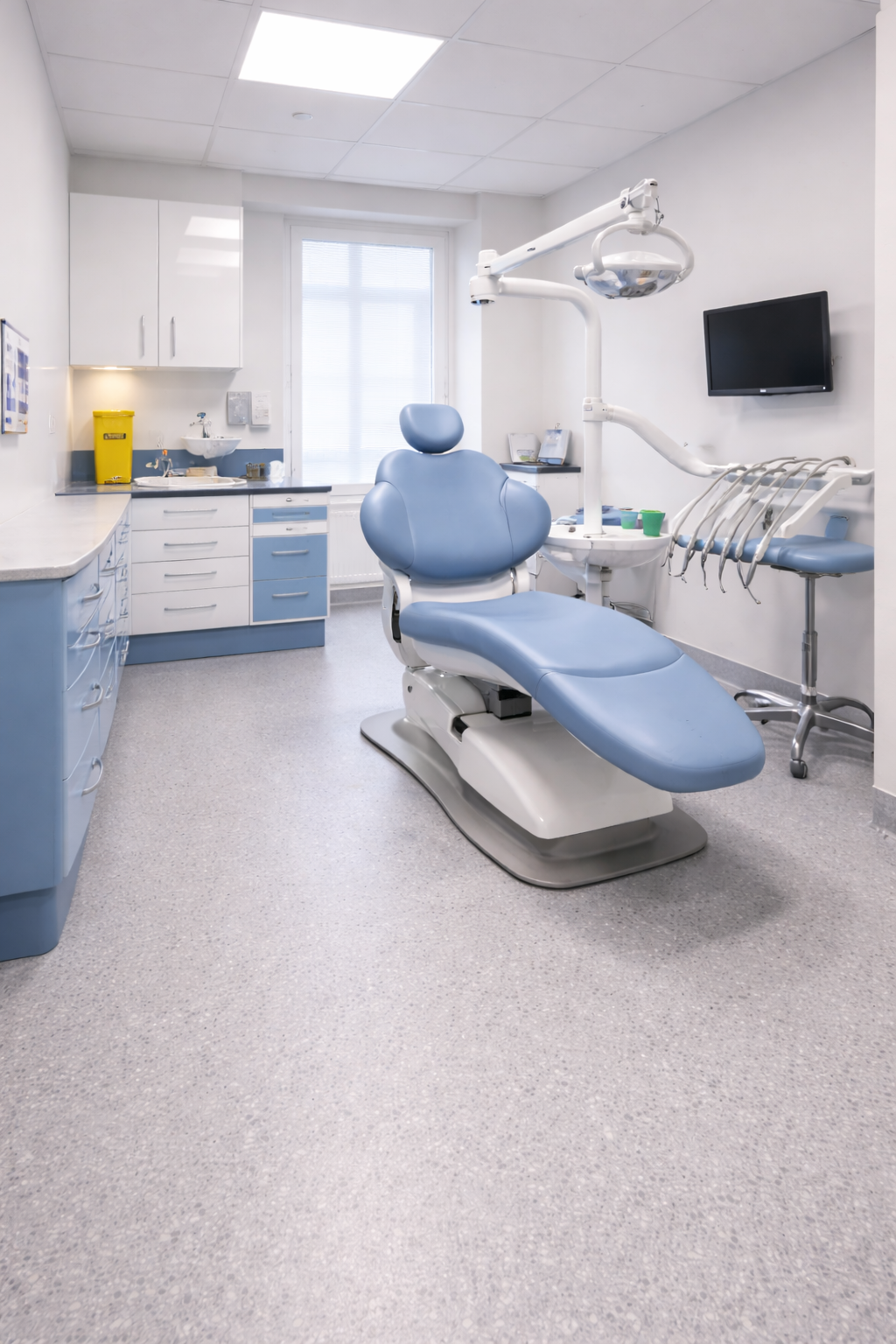 Hygienic vinyl safety flooring installed in a modern UK dental surgery treatment room with dental chair and equipment