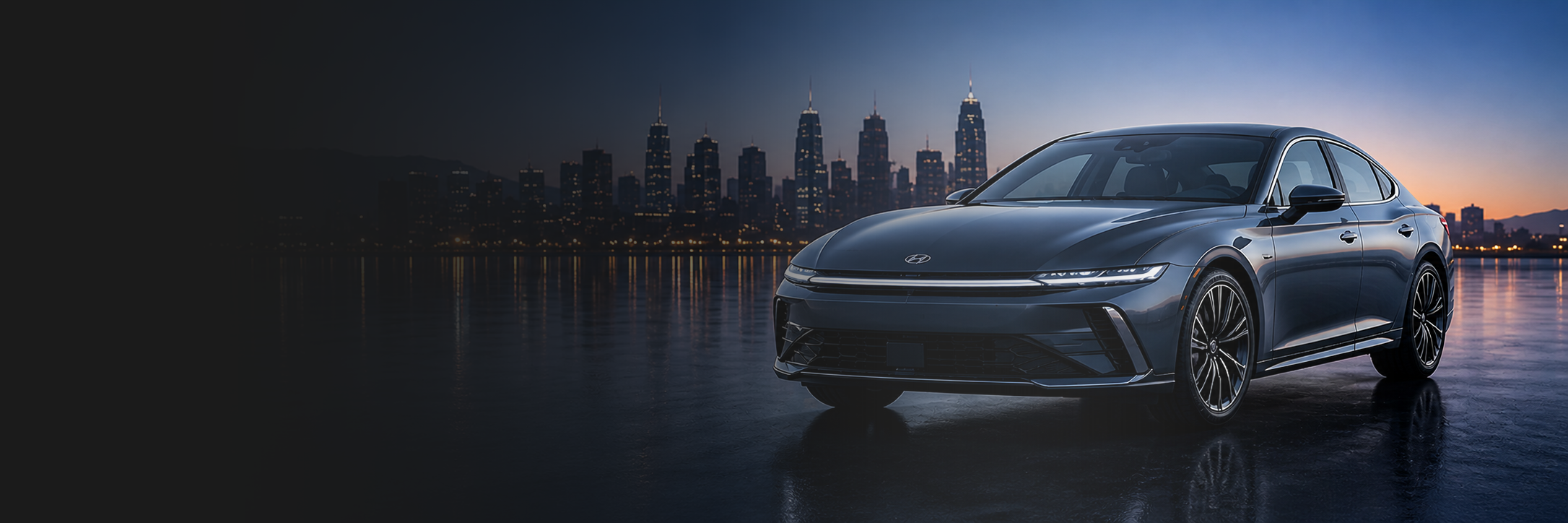 Black Hyundai electric sedan parked by the water with a city skyline at sunset with a clear windshield