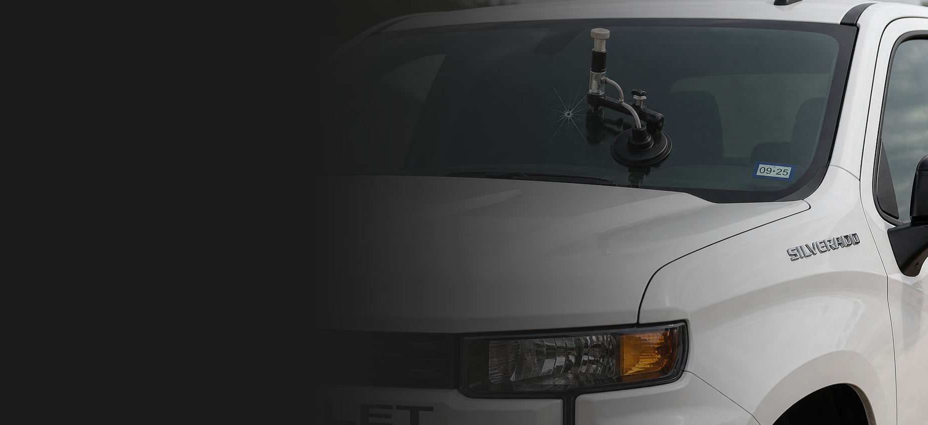Cracked windshield repair on a Chevrolet Silverado using a chip repair bridge