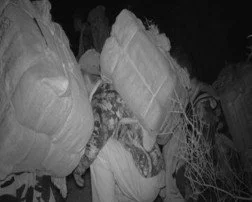 Marijuana smugglers wait for their load vehicle within feet of our covert camera, unaware they were being watched. Moments like this one took hundreds of hours of surveillance to capture. The patience eventually paid off.