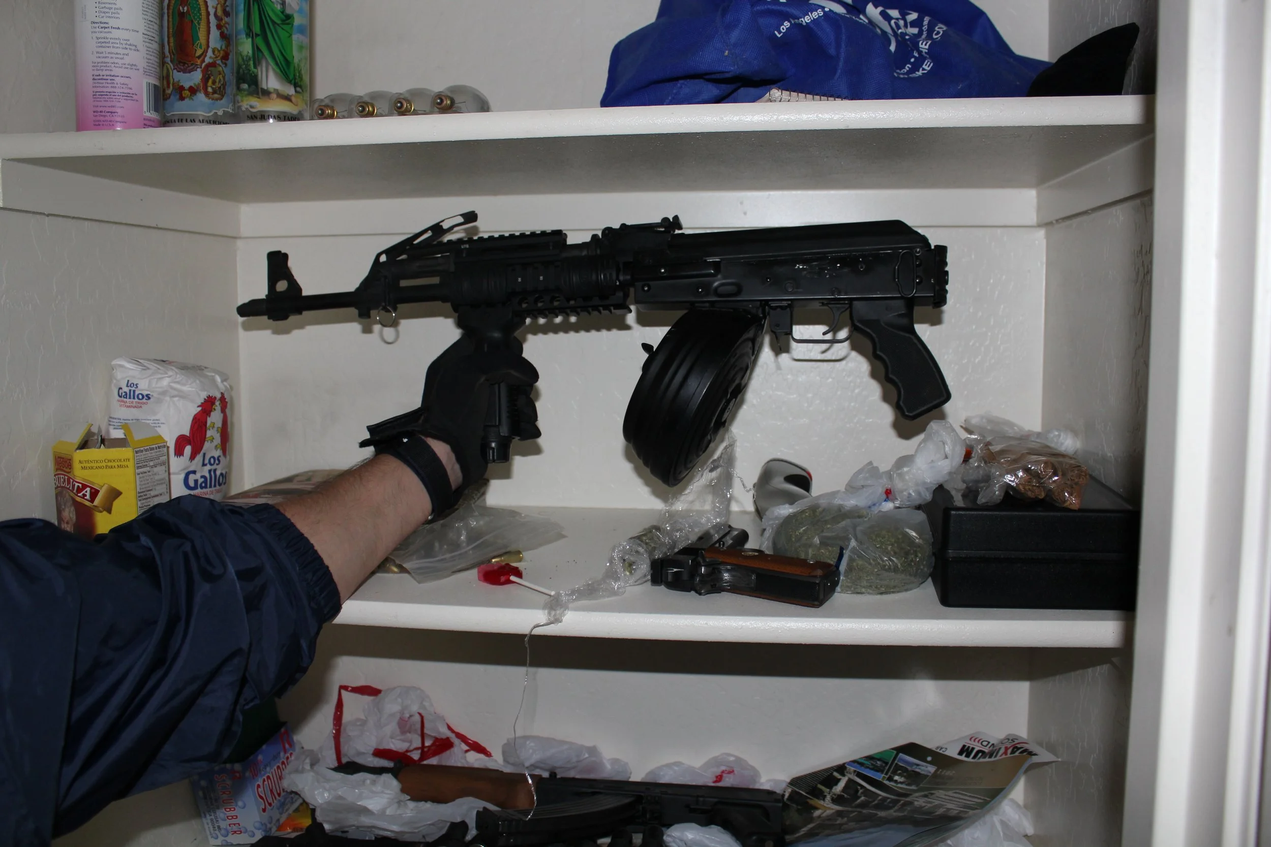 This is how the network protected itself. Weapons seized during Operation Pipeline Express, including AK variants and high-capacity magazines.
