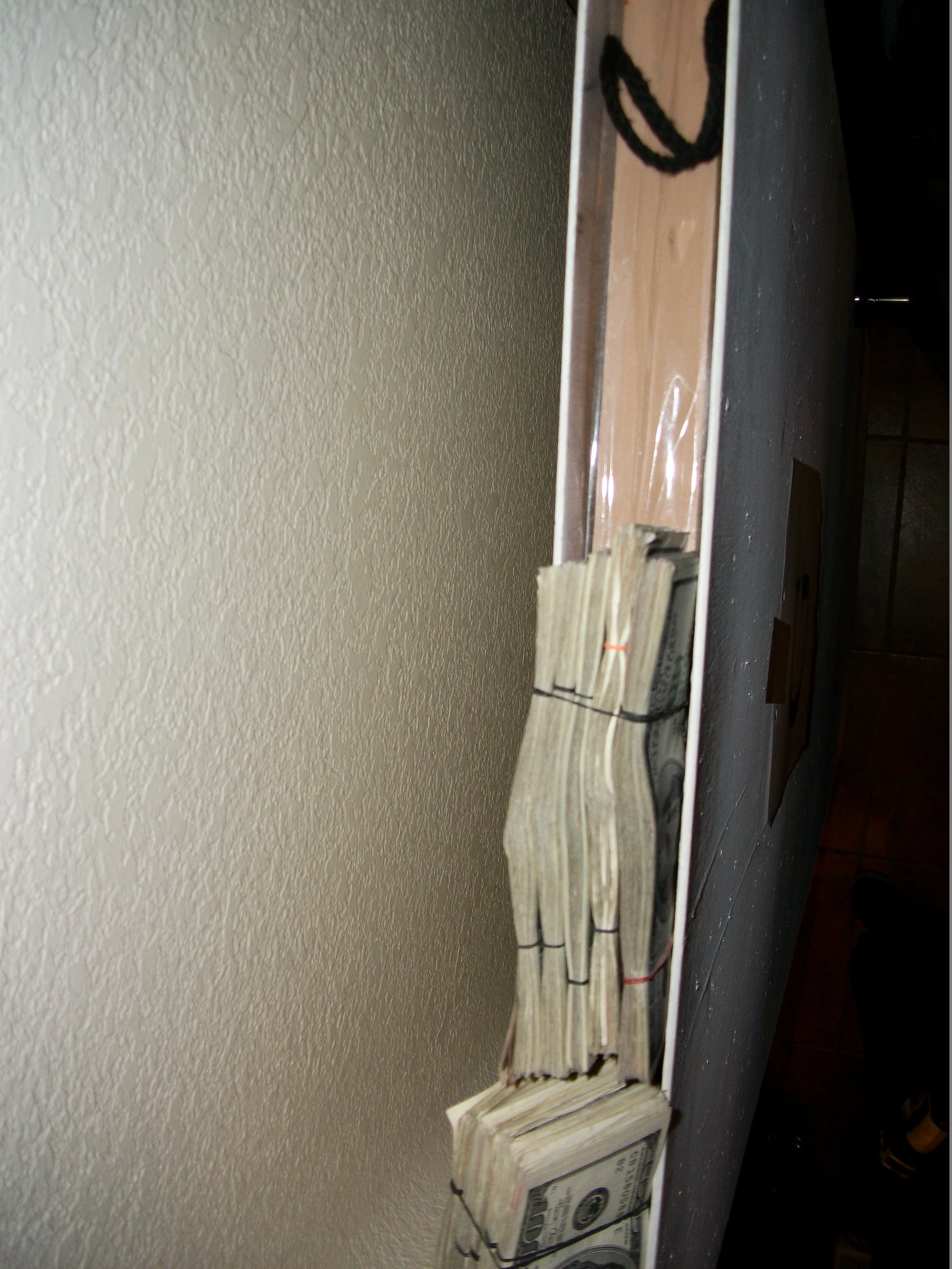 More than $250,000 concealed inside a hollow interior door at a Phoenix stash house. Cash like this moved as easily as the drugs which were hidden in plain sight.