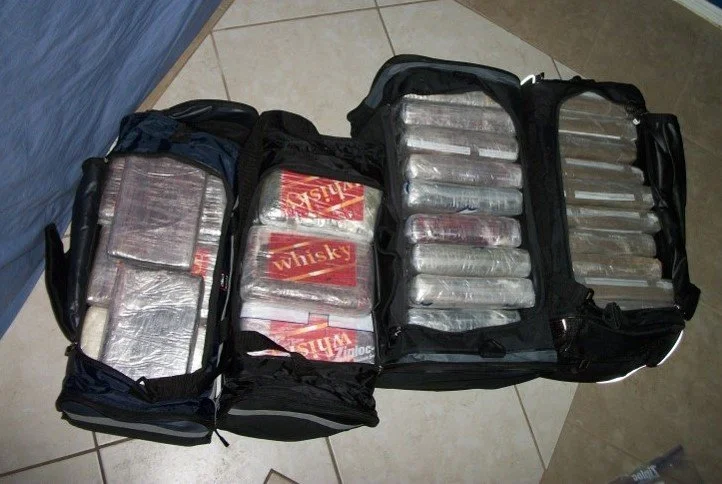 Cocaine seized in Phoenix, marked “WHISKY” to identify ownership within the network. Loads like this moved from South America through the same pipeline into US distribution hubs.
