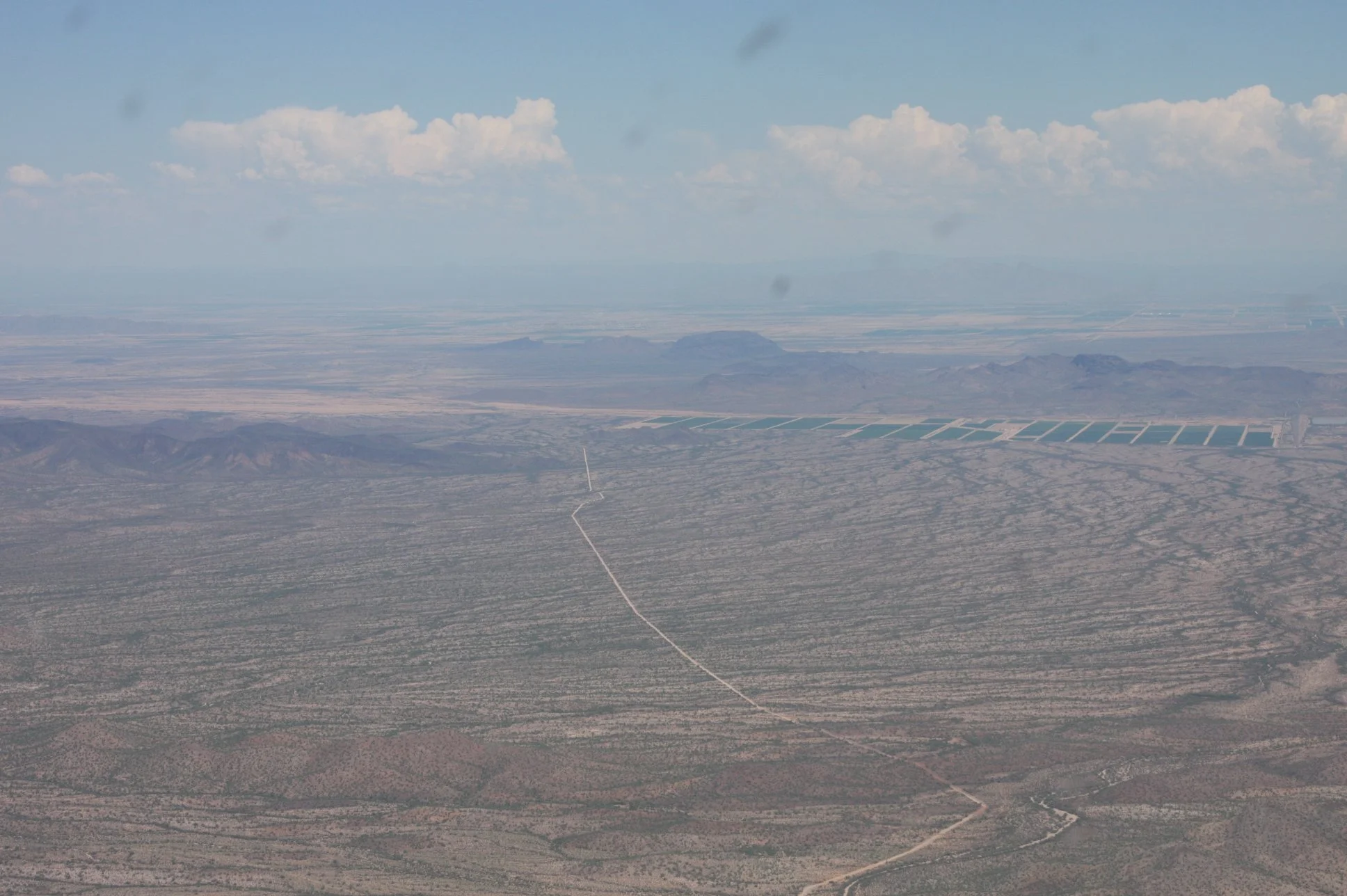 Aerial view of the pipeline corridor near Stanfield, Arizona. From the ground, movement looked random. From the air, the pattern was clear, it was a supply route moving drugs and people north, and guns and cash south.