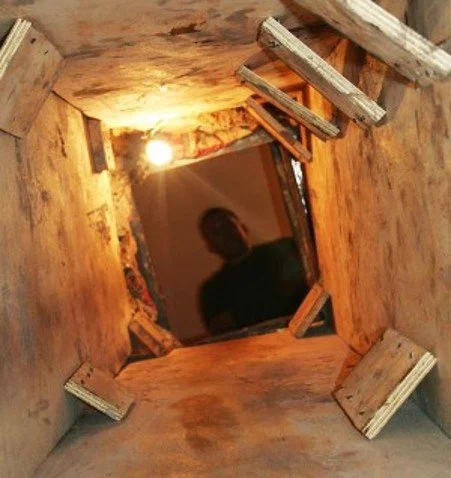 The inside of a subterranean tunnel beneath the US/Mexico border which are engineered for speed, not comfort. The figure at the end gives you the scale. People and drugs moved through passages like this one around the clock, unseen, beneath neighborh