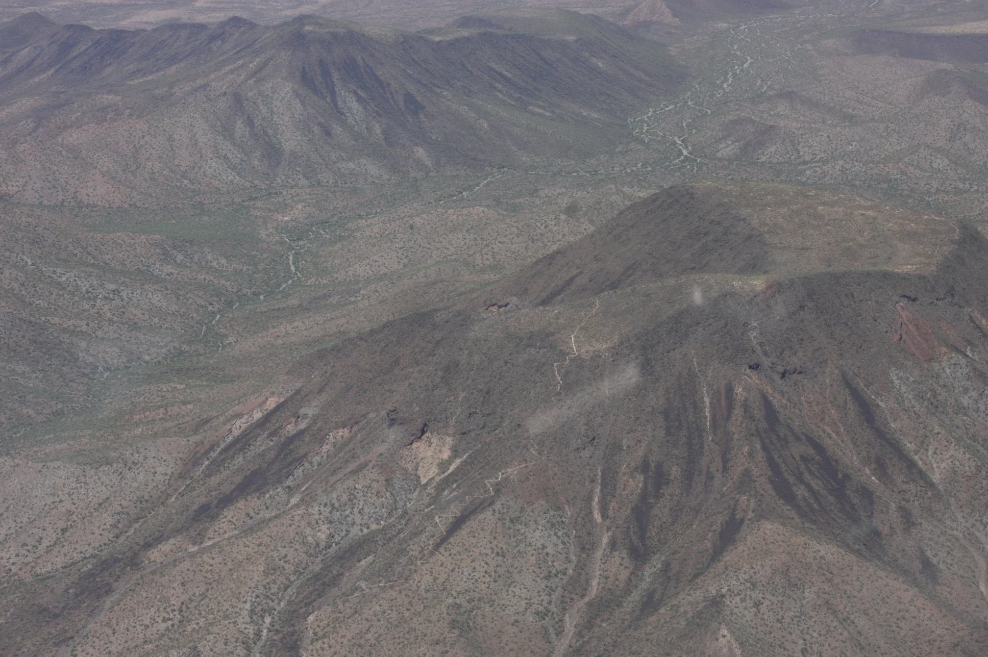 Ninety miles of open desert between the border and Phoenix partly photographed from a CBP helicopter during active surveillance. From the air, the smuggling corridor was obvious. From the ground, it looked like nothing at all. That gap was the networ